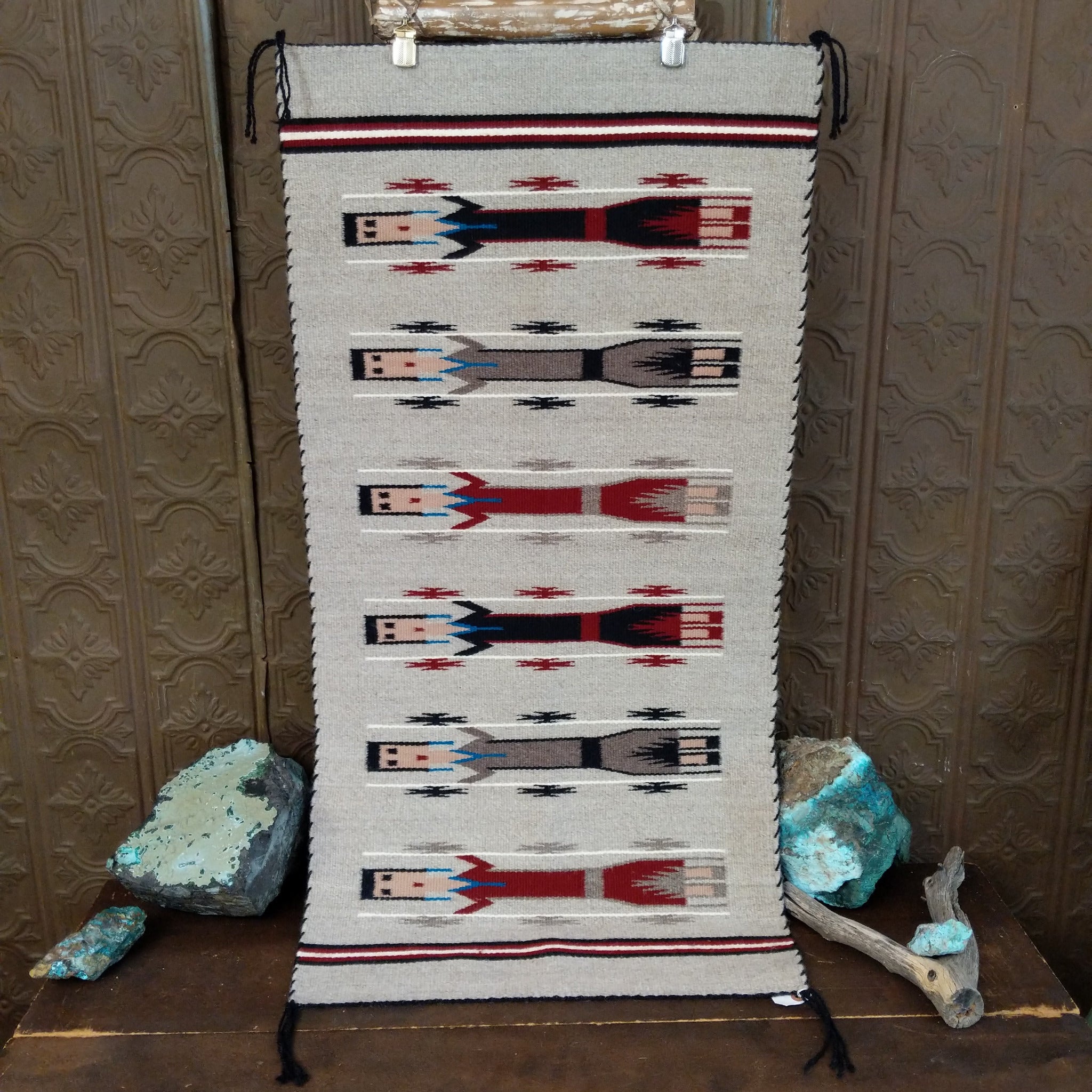 Yei Navajo Rug shows three traditional Yei figures woven against a natural gray background