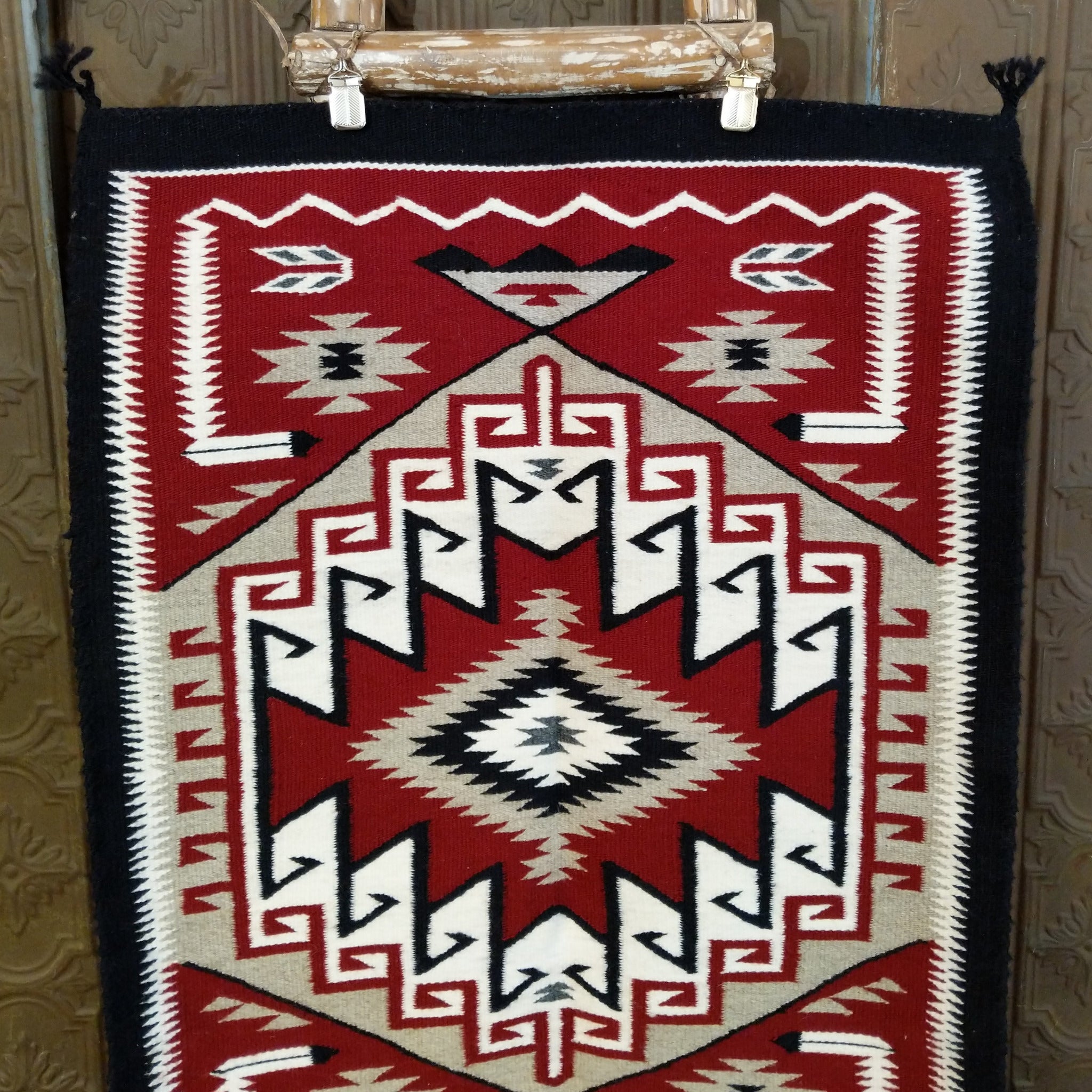 Klagetoh Navajo Rug shows a classic stepped diamond design in deep red, black, ivory, and gray