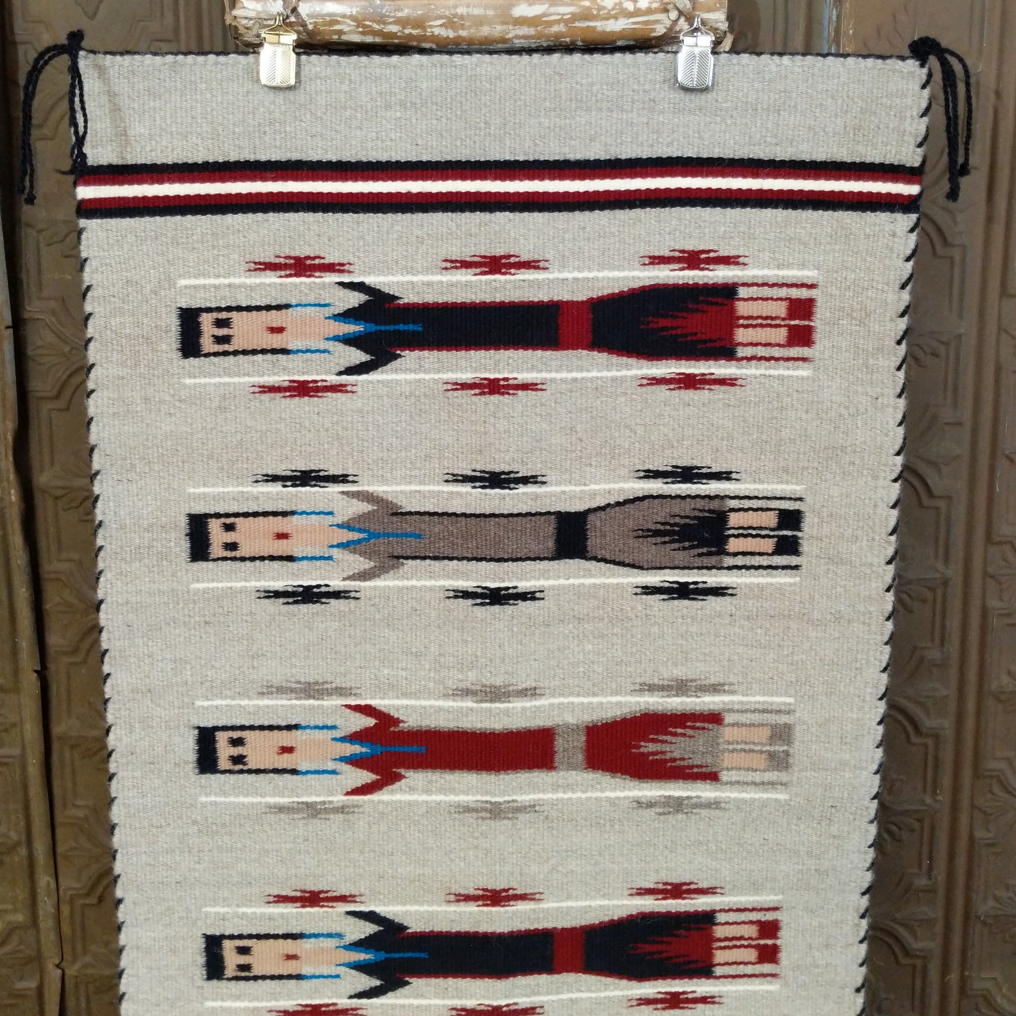 Yei Navajo Rug shows three traditional Yei figures woven against a natural gray background