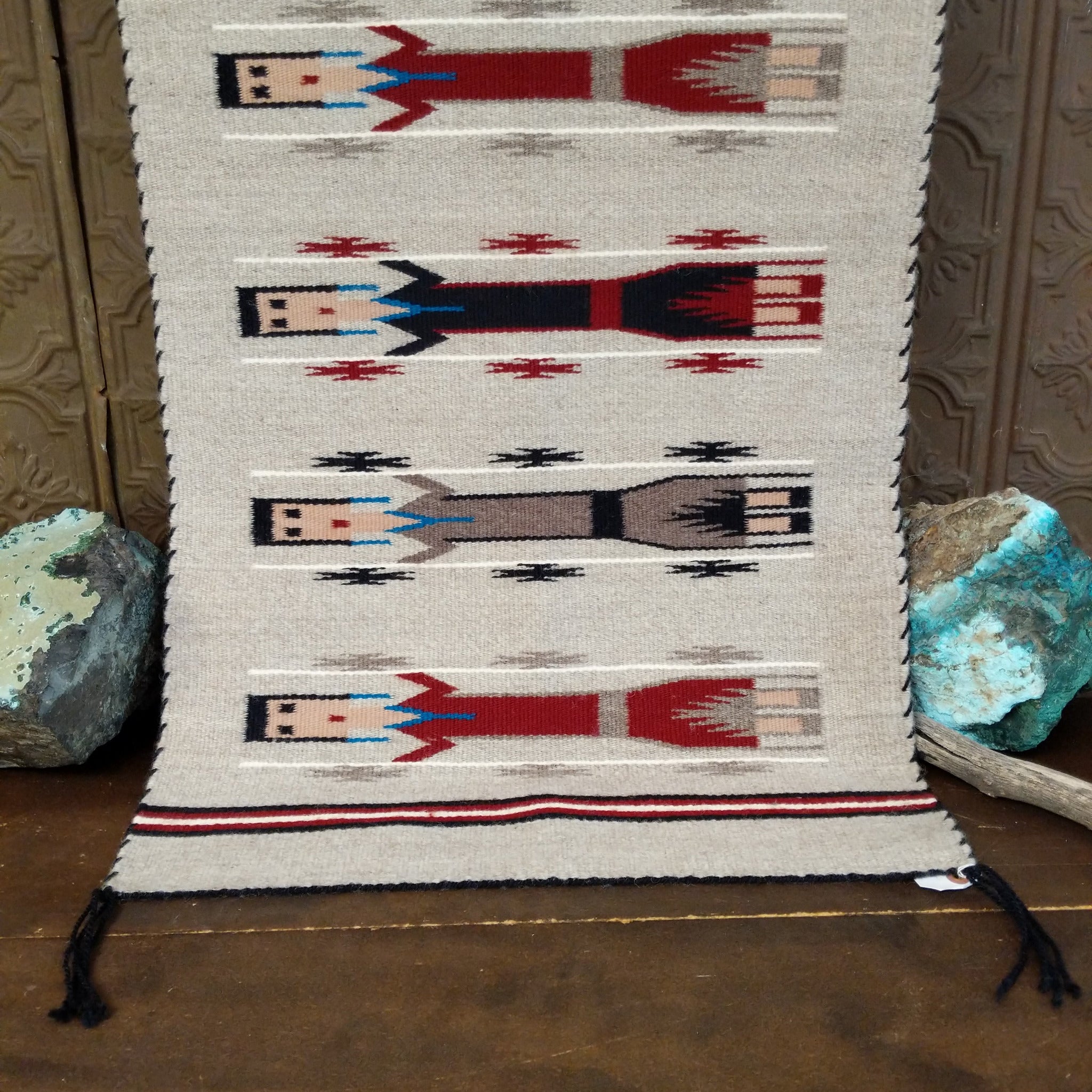 Yei Navajo Rug shows three traditional Yei figures woven against a natural gray background