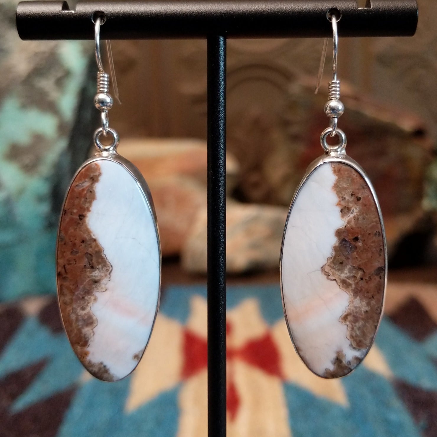 Sterling silver earrings with Arizona blue opal set in oval bezels.
