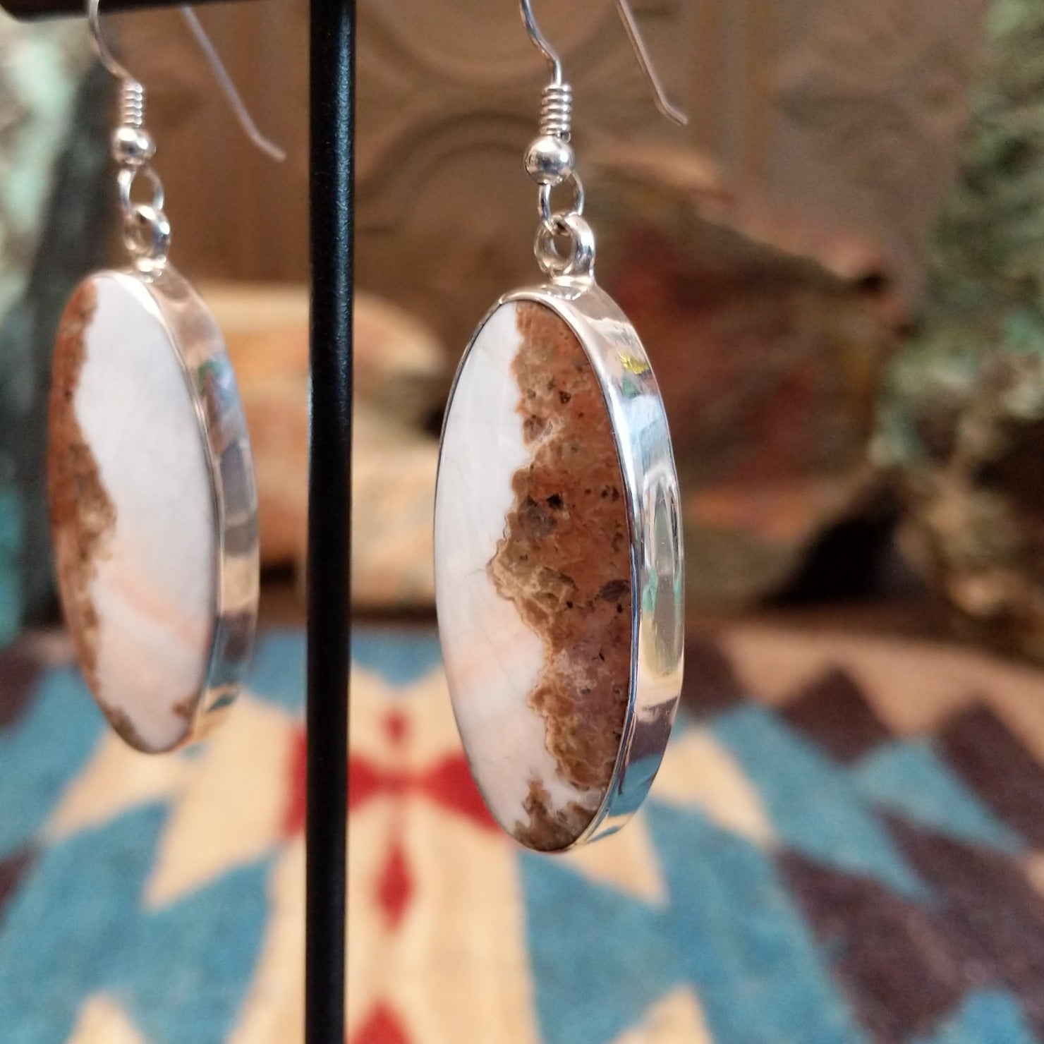Sterling silver earrings with Arizona blue opal set in oval bezels.