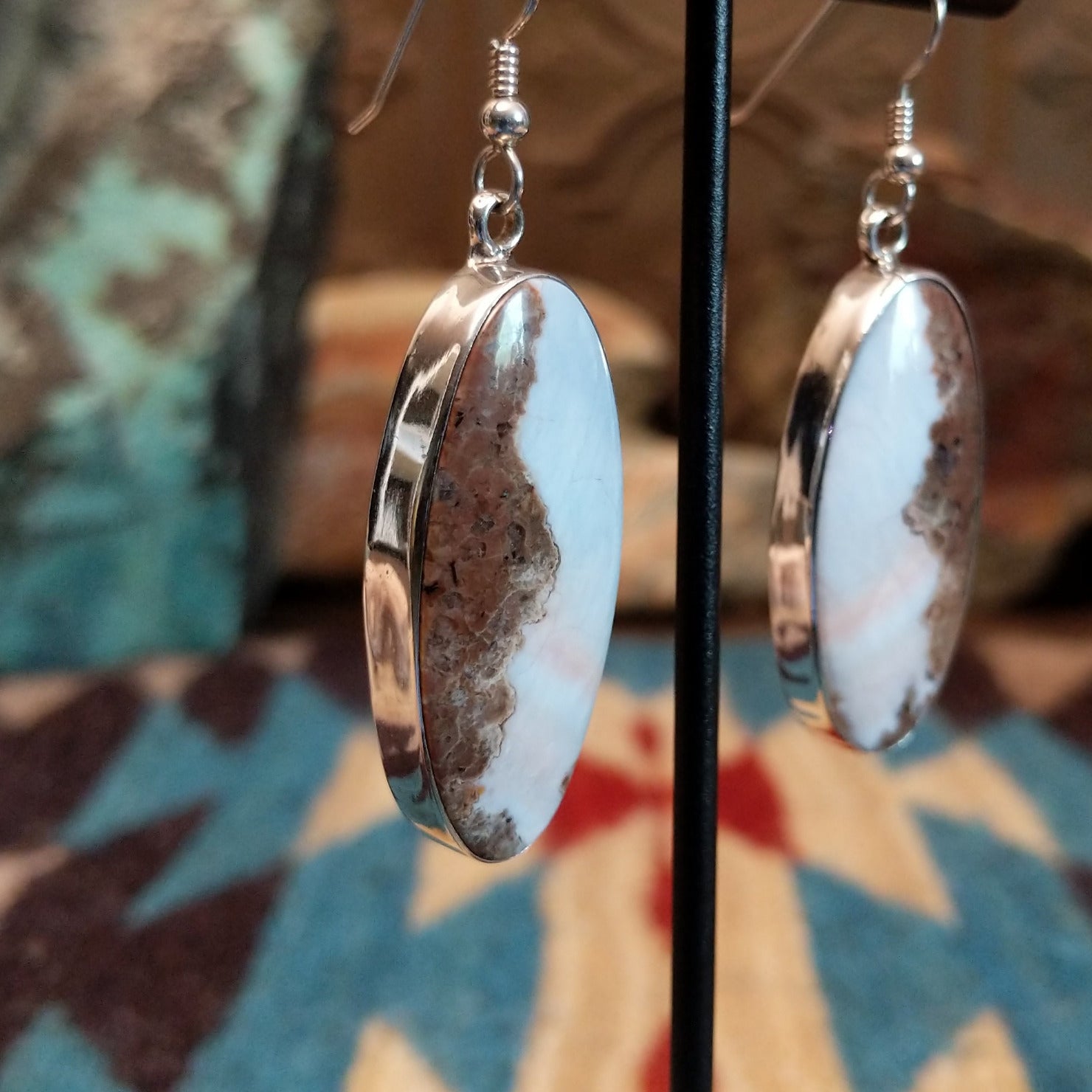 Sterling silver earrings with Arizona blue opal set in oval bezels.