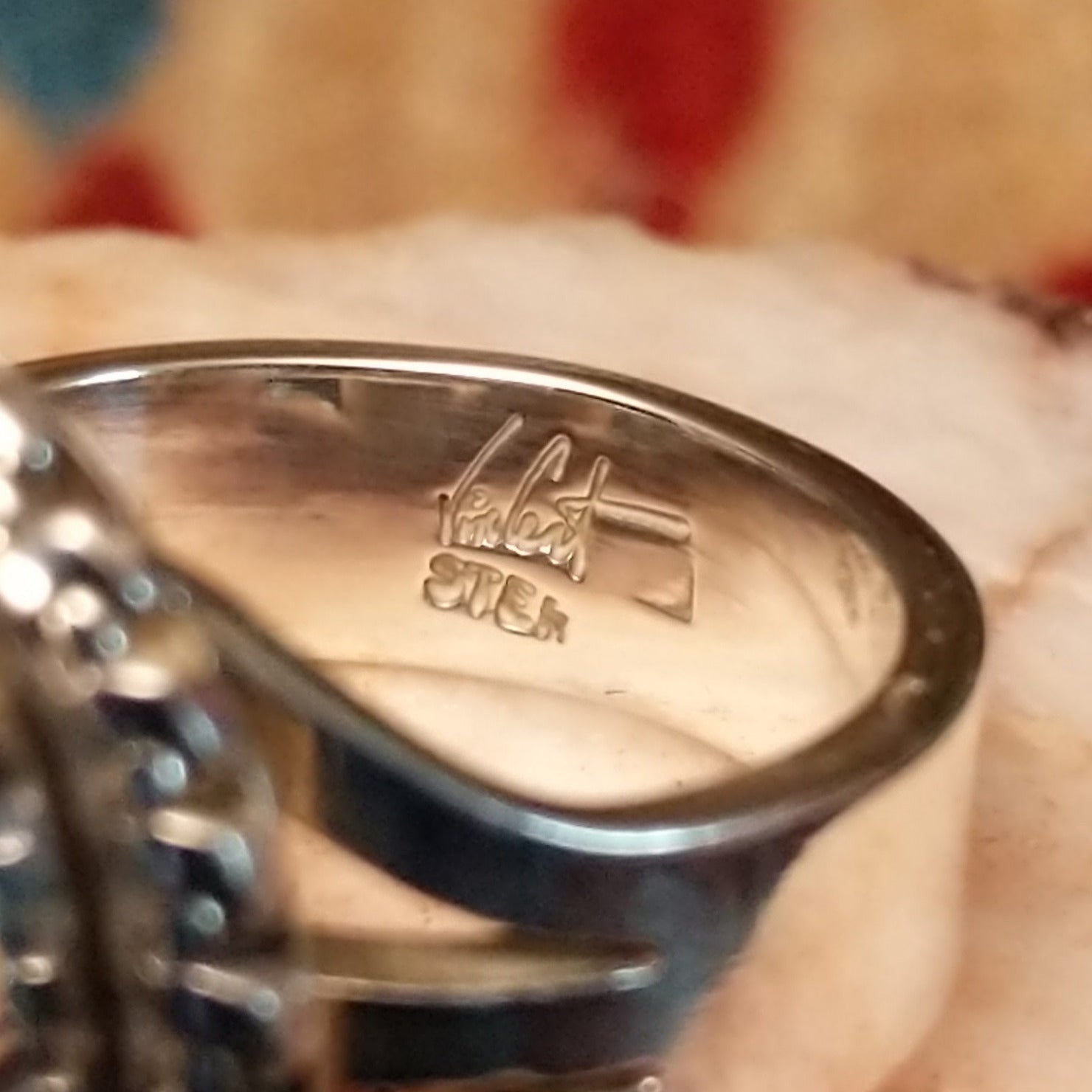Close-up of the artisan's stamped signature.