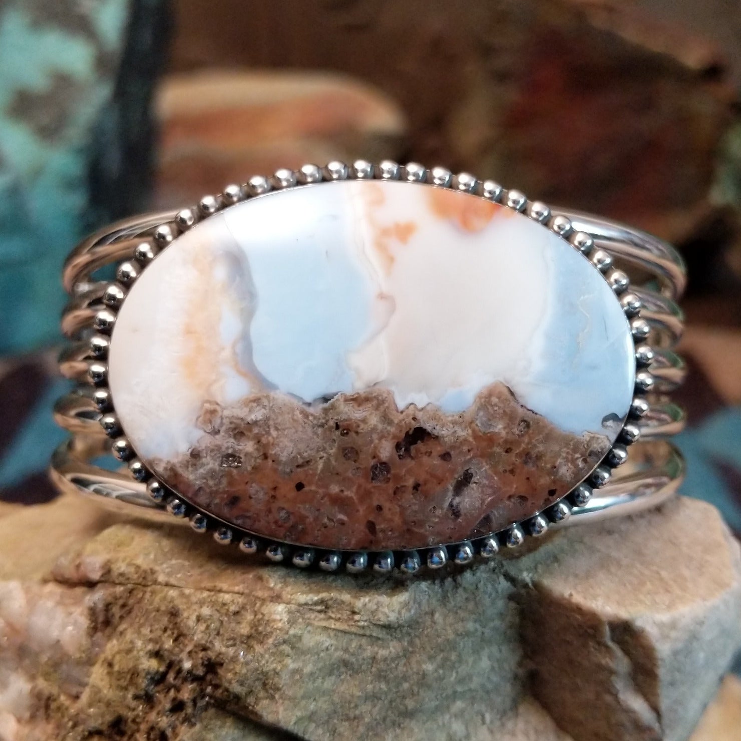 Sterling silver cuff with Arizona blue opal set in the oval bezel, framed by dotted accents.