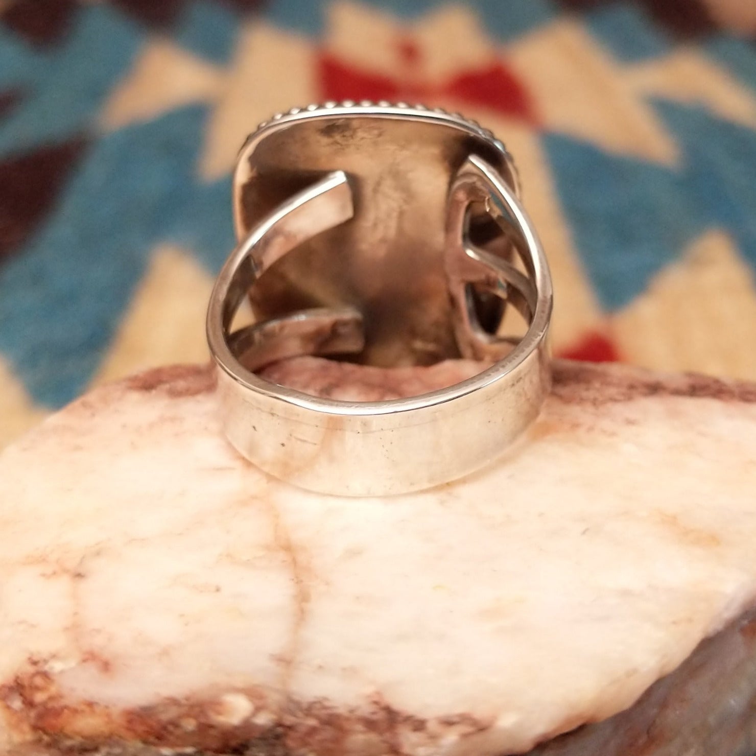 Sterling silver ring with Arizona blue opal set in the large bezel, framed by ribbed silverwork.