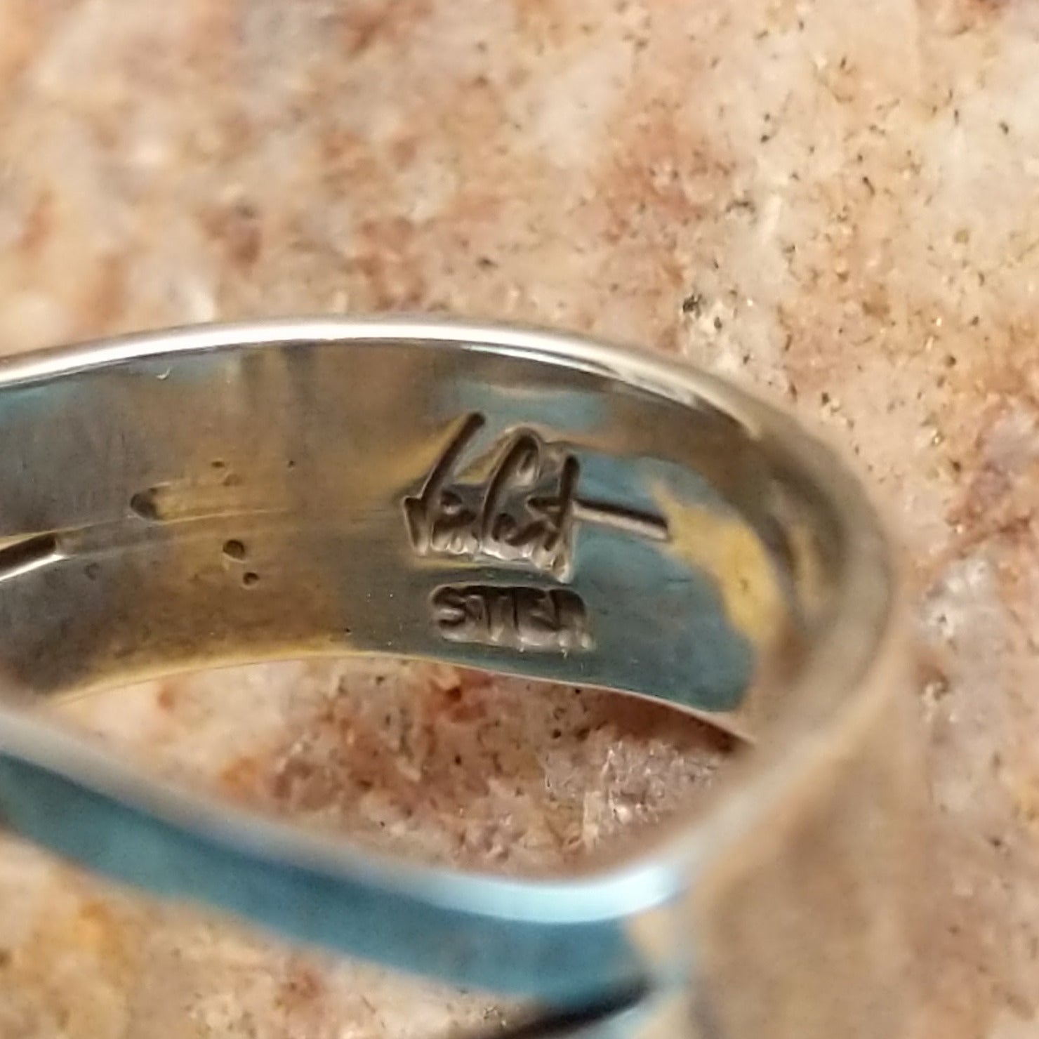 Close-up of the artisan's stamped signature.