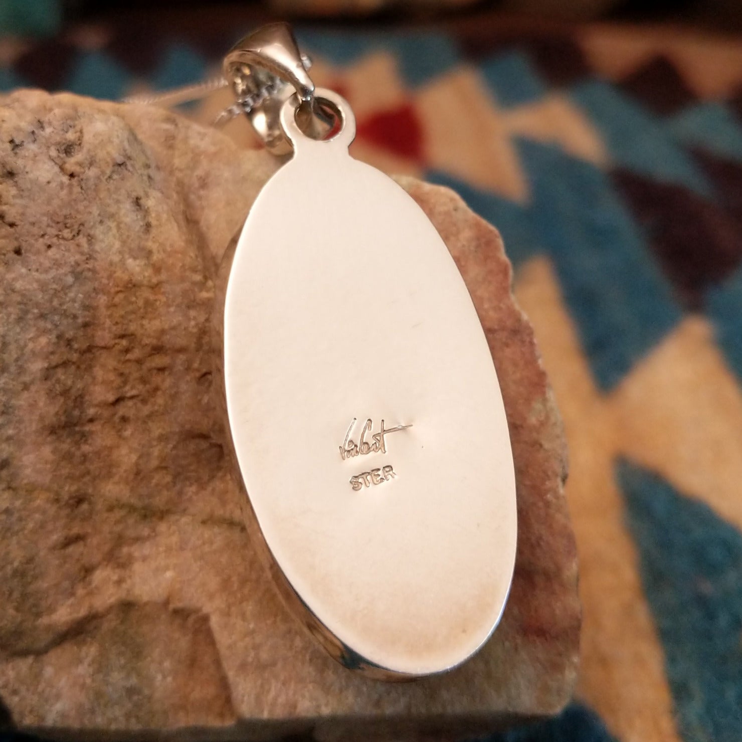 Close-up of the artisan's stamped signature.