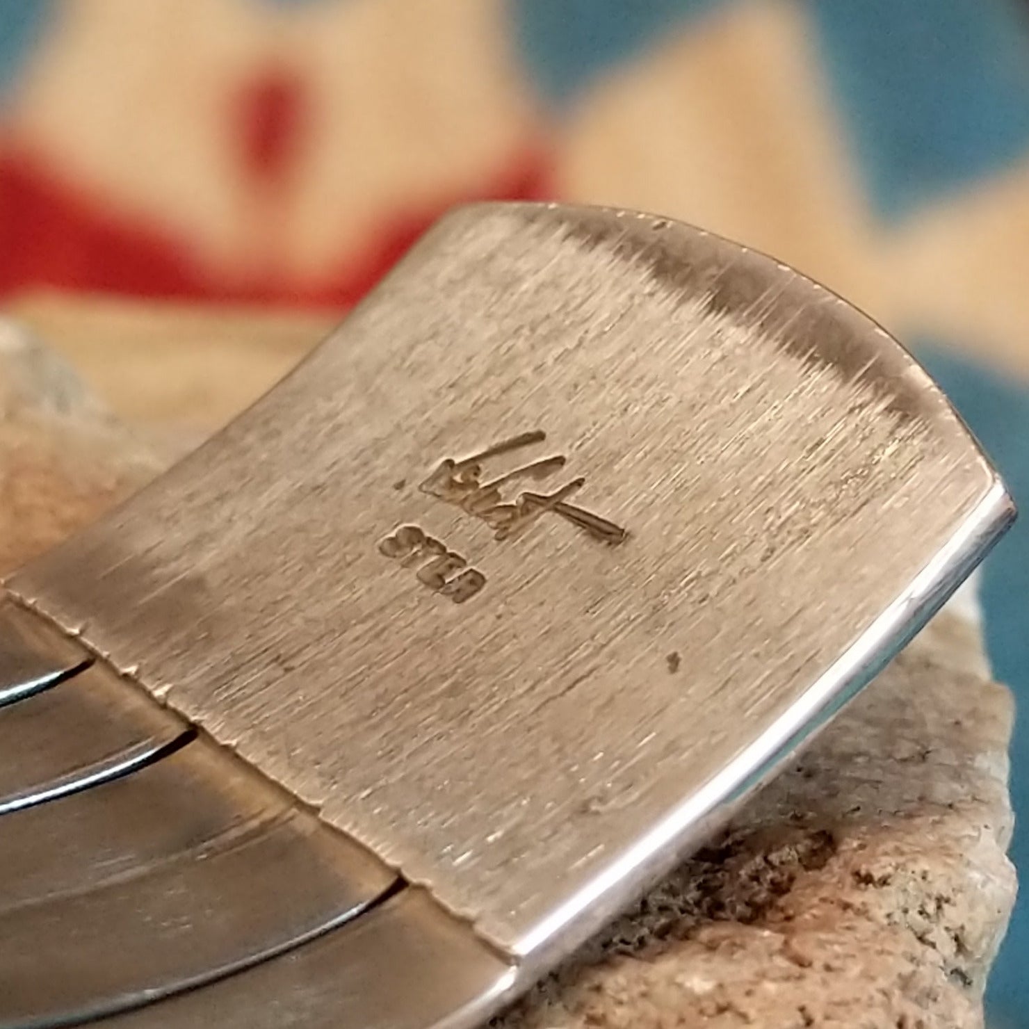 Close-up of the artisan's stamped signature.