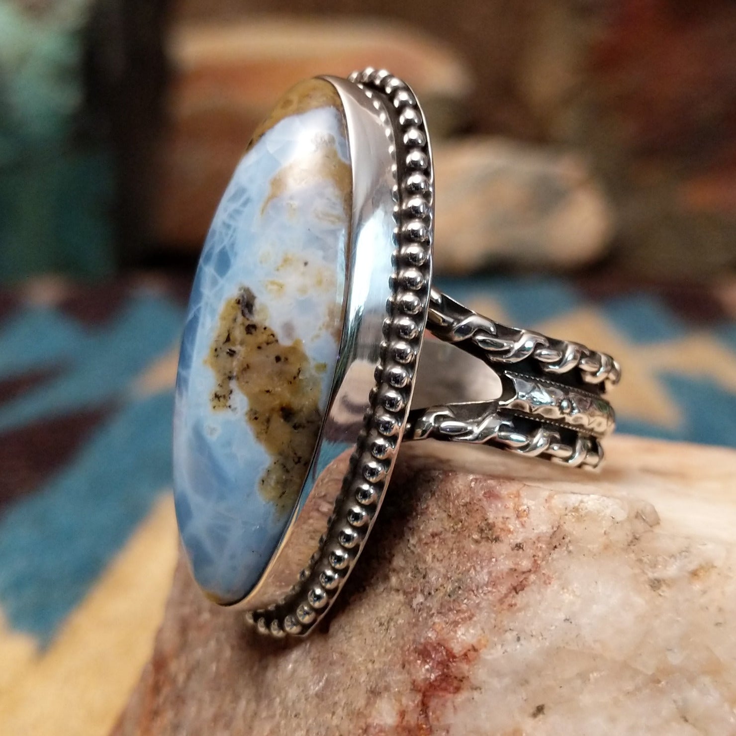 Sterling silver ring with Arizona blue opal set in the large oval bezel, framed by dotted accents.