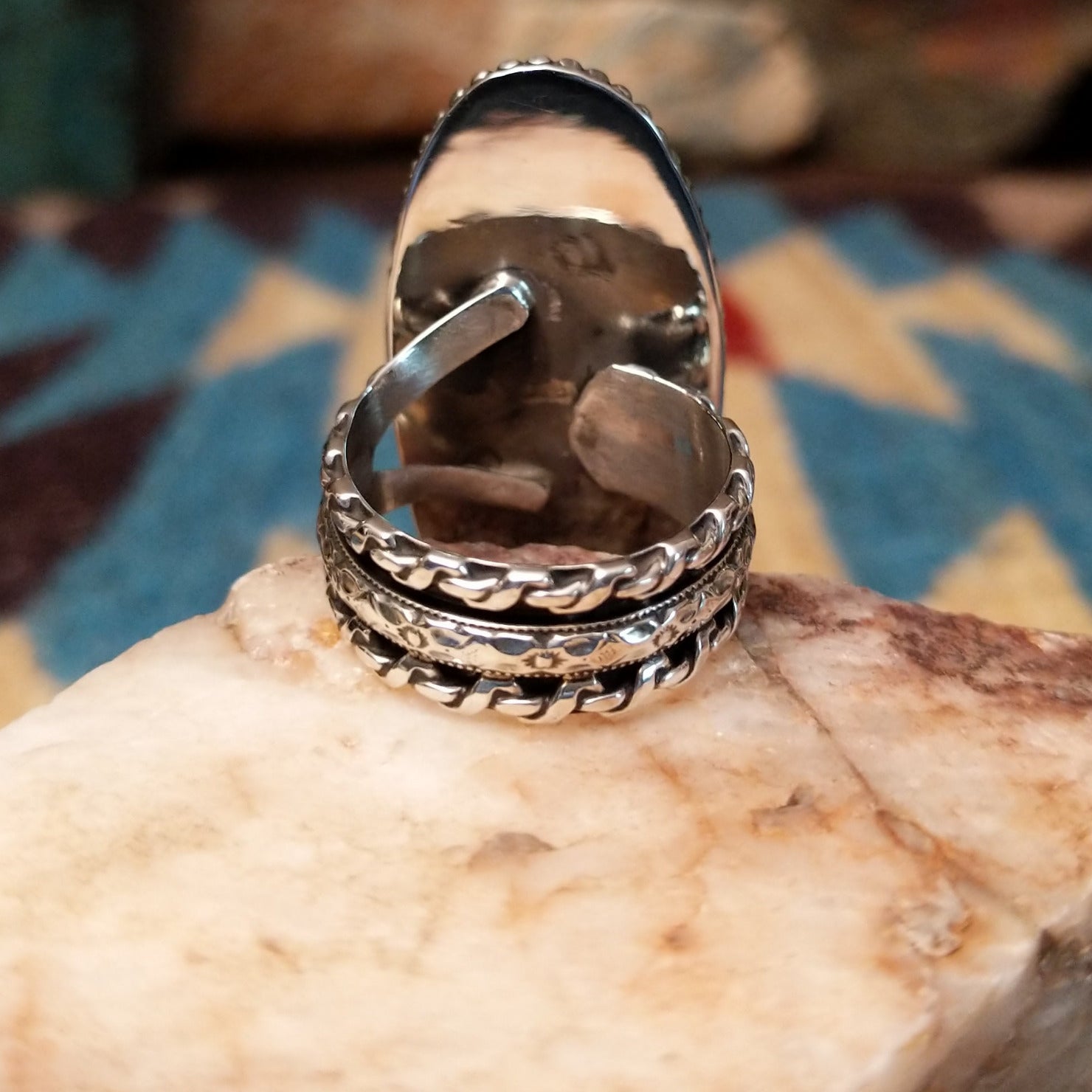 Sterling silver ring with Arizona blue opal set in the large oval bezel, framed by dotted accents.