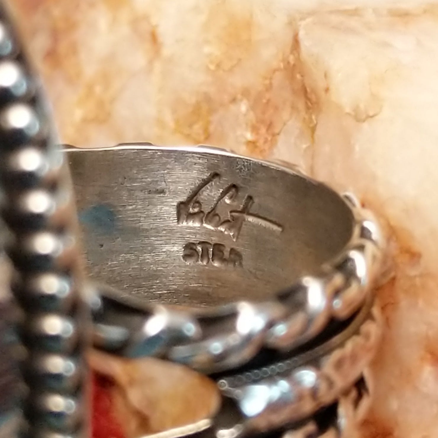 Close-up of the artisan's stamped signature.