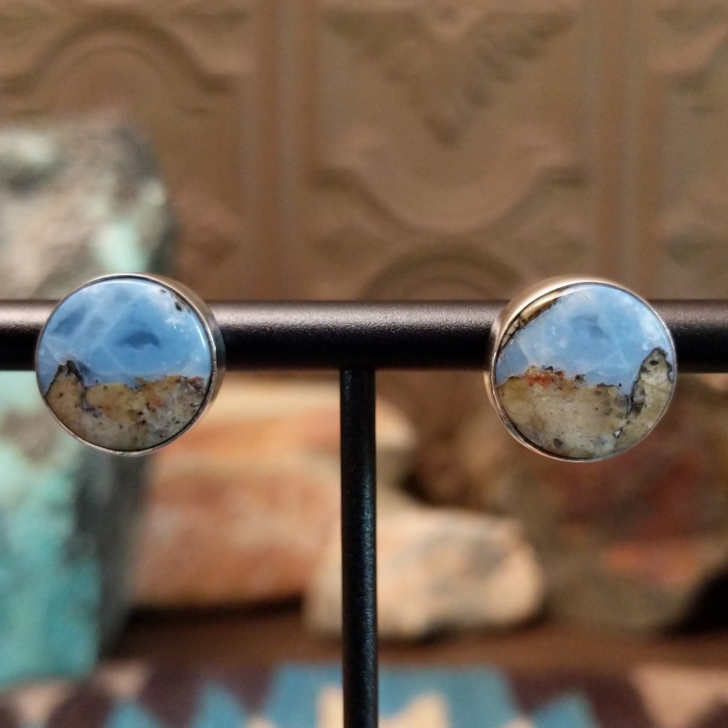Sterling silver post earrings with Arizona blue opal set in round bezels.