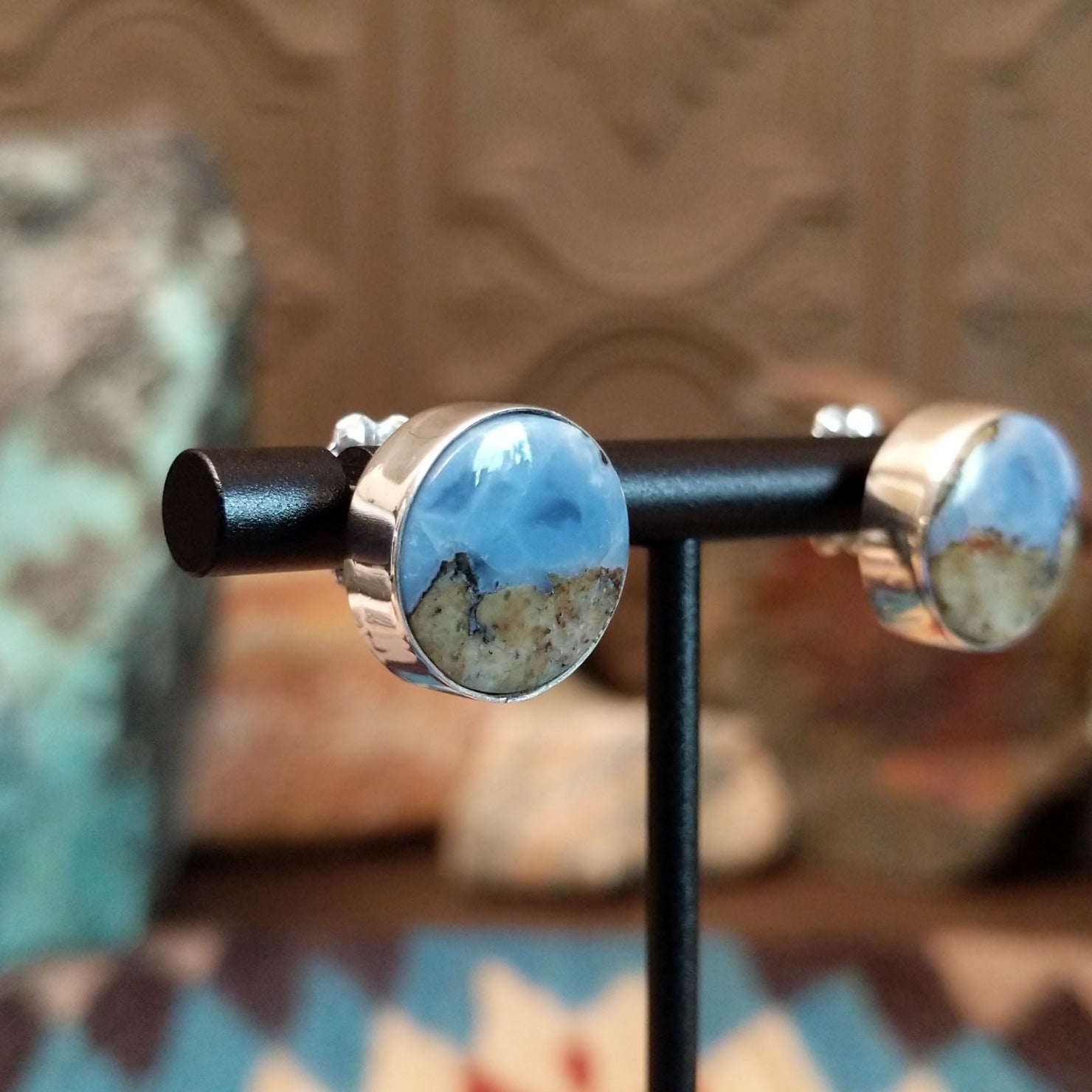 Sterling silver post earrings with Arizona blue opal set in round bezels.