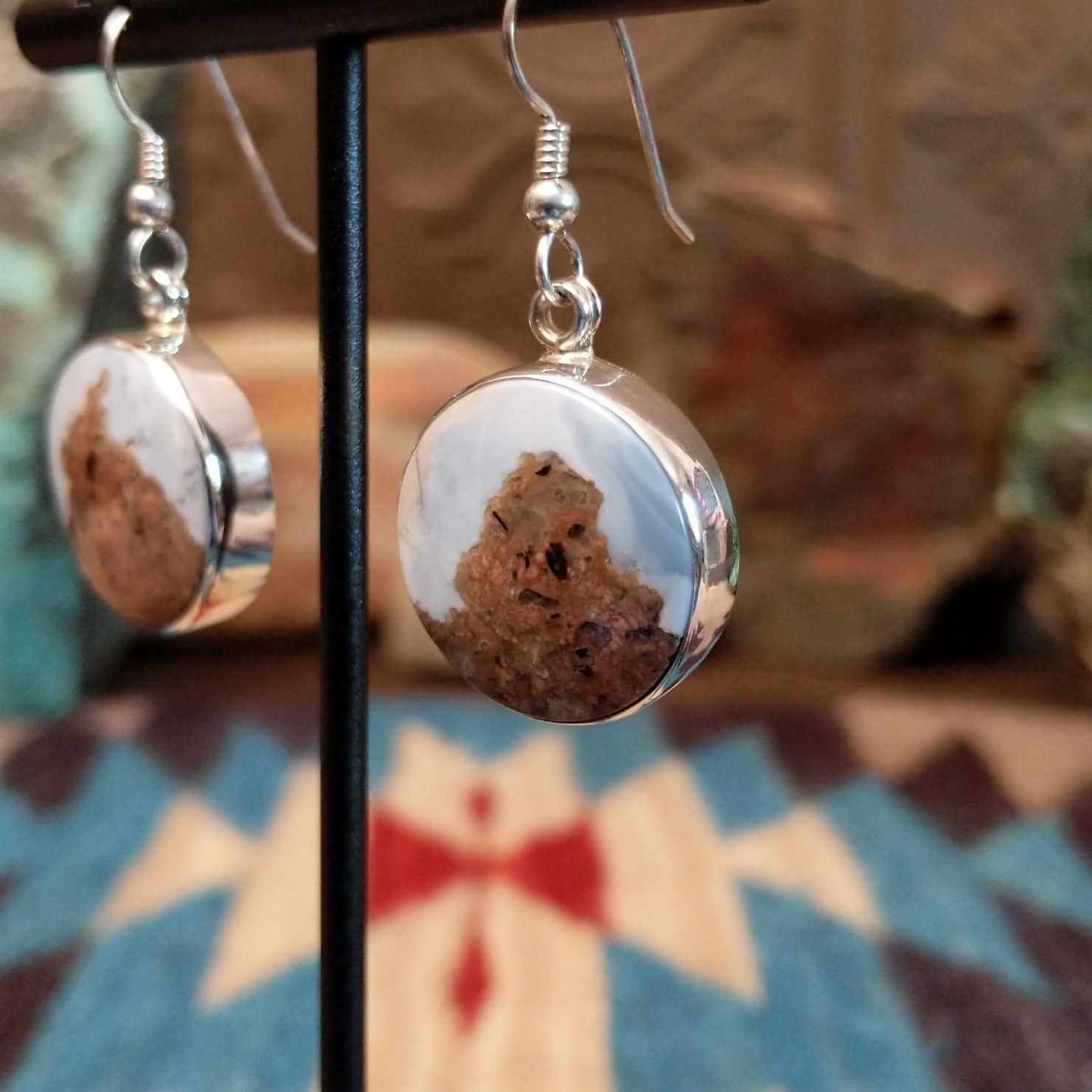 Sterling silver dangle earrings with Arizona blue opal set in round bezels.