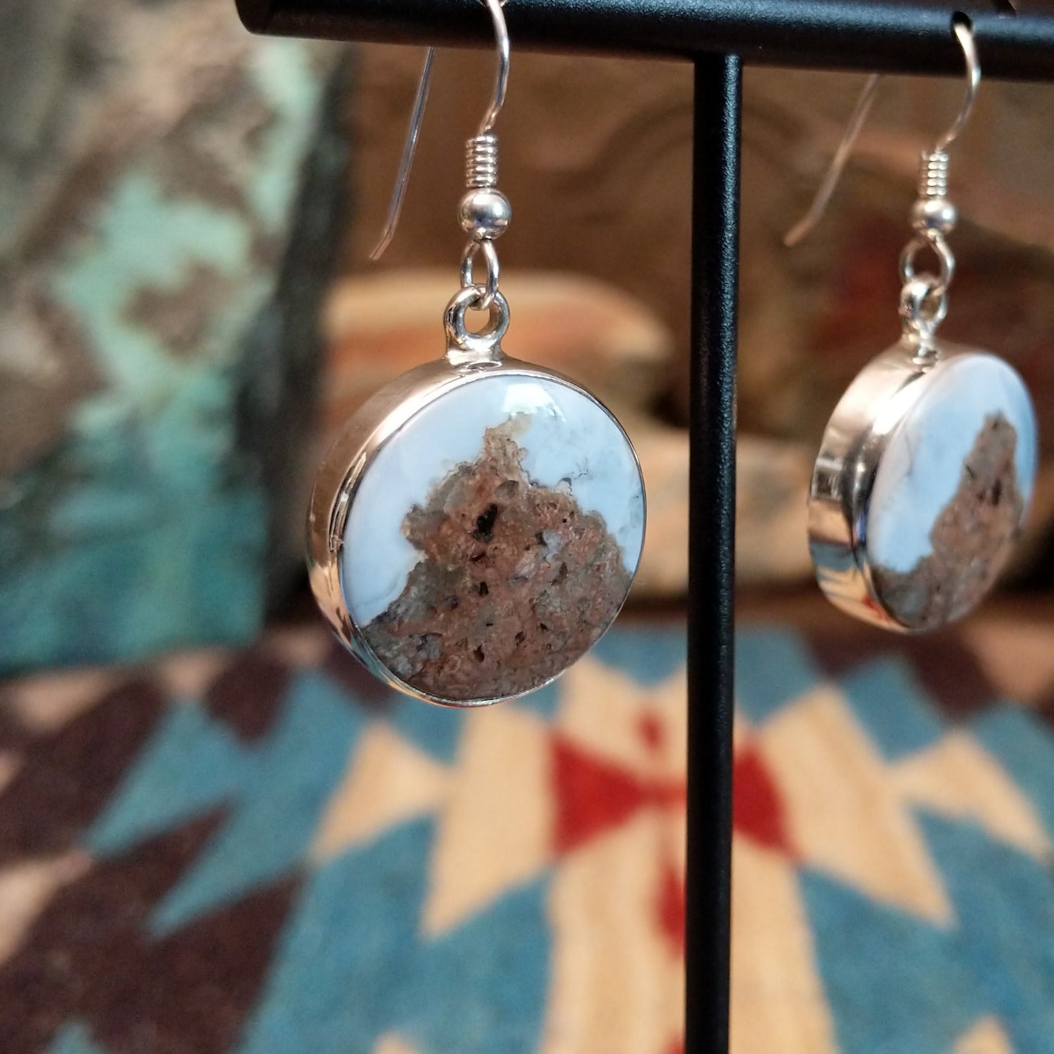 Sterling silver dangle earrings with Arizona blue opal set in round bezels.