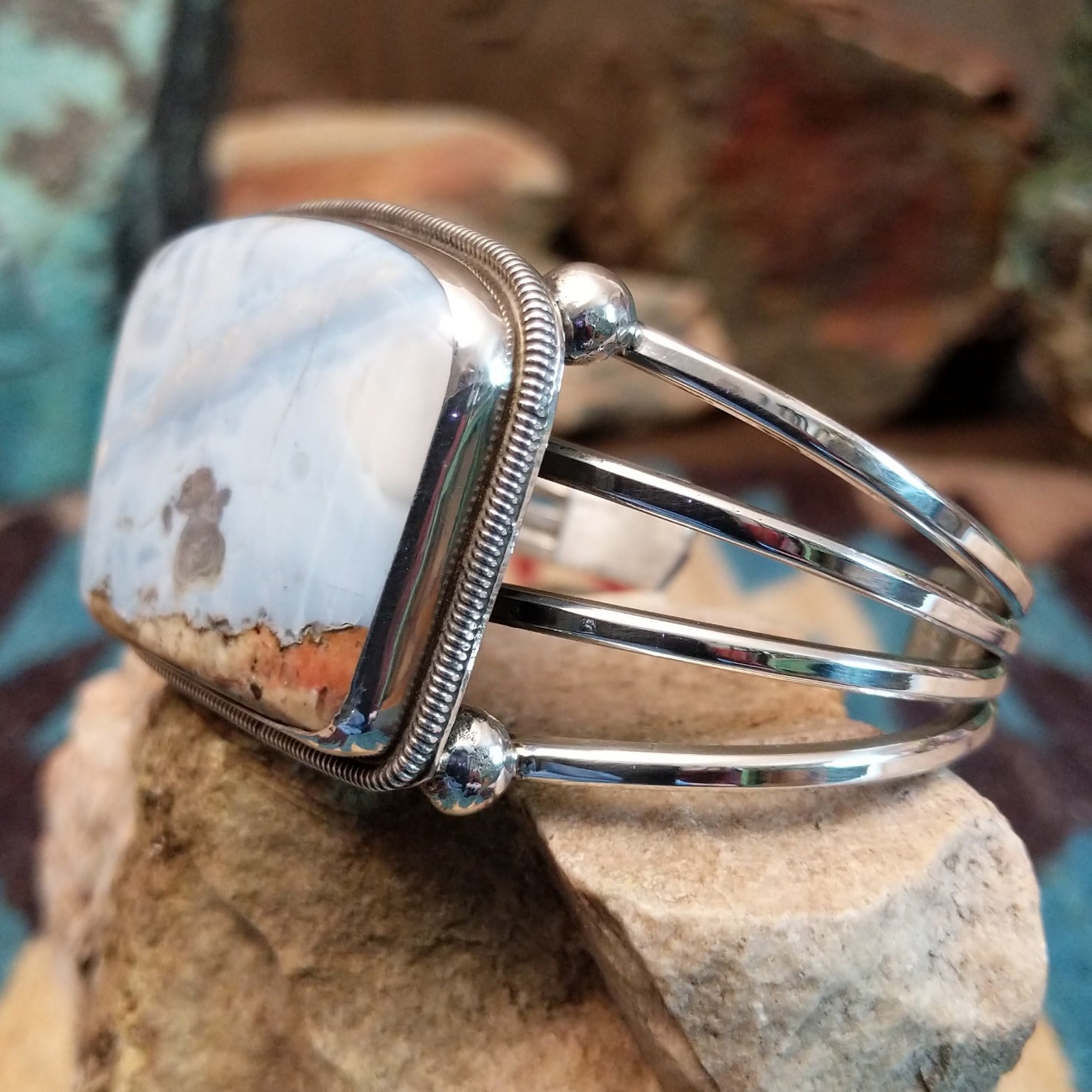 Sterling silver cuff bracelet with Arizona blue opal set in the large bezel, framed by ribbed silverwork.