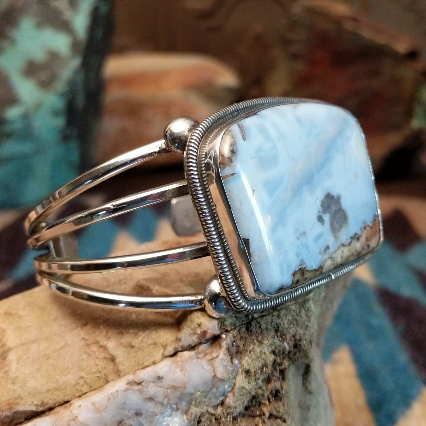 Sterling silver cuff bracelet with Arizona blue opal set in the large bezel, framed by ribbed silverwork.