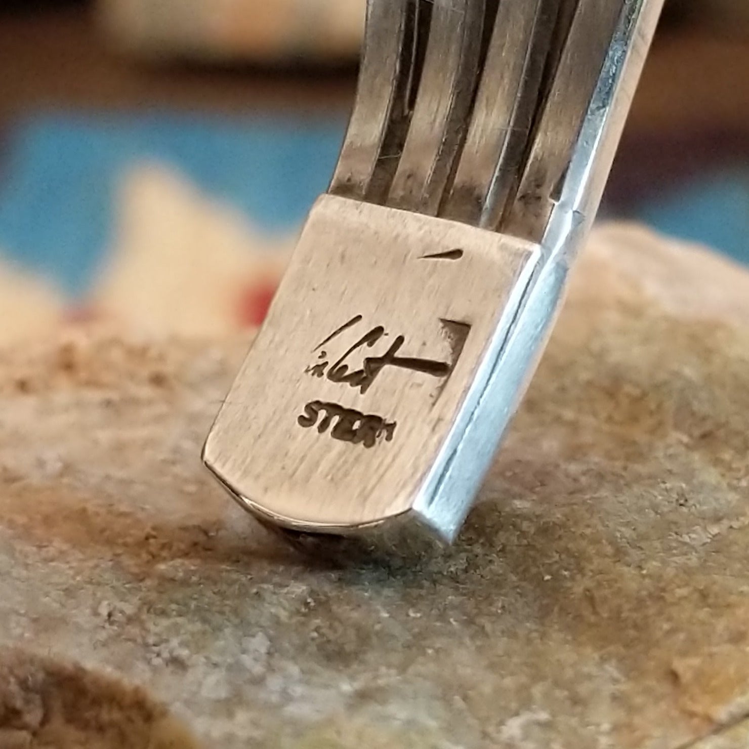 Close-up of the artisan's stamped signature.