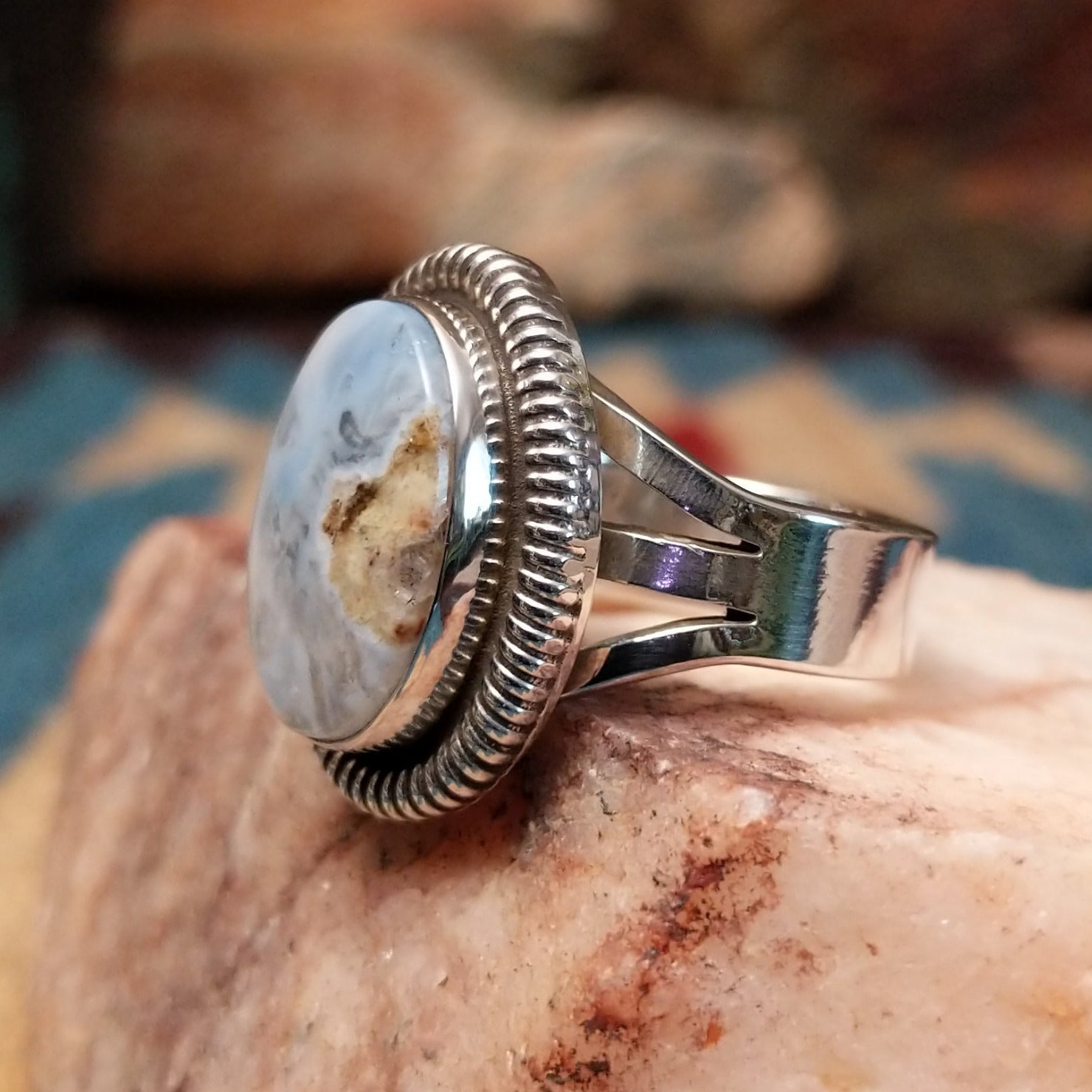 Sterling silver ring with Arizona blue opal set in the oval bezel, framed by ribbed silverwork.