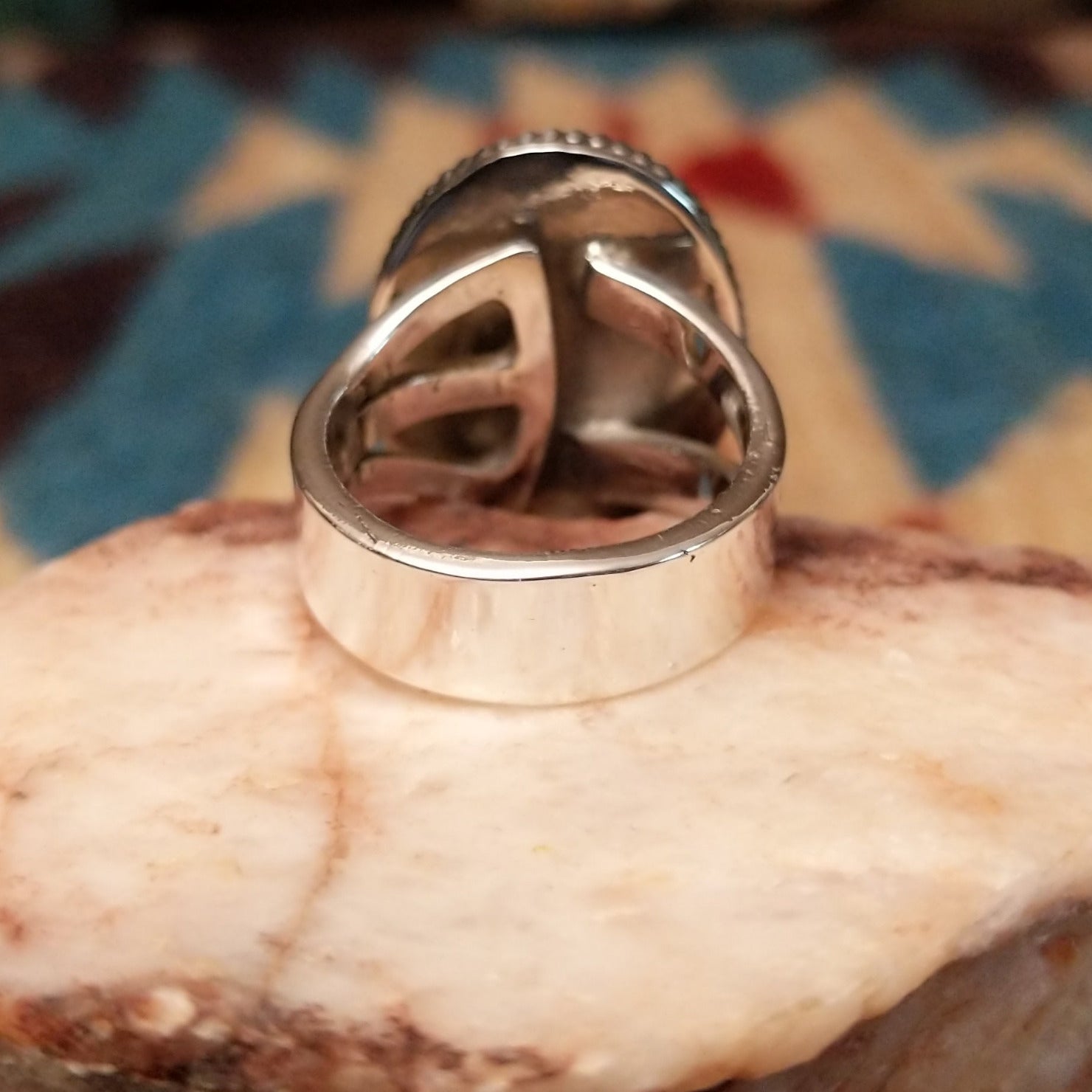 Sterling silver ring with Arizona blue opal set in the oval bezel, framed by ribbed silverwork.