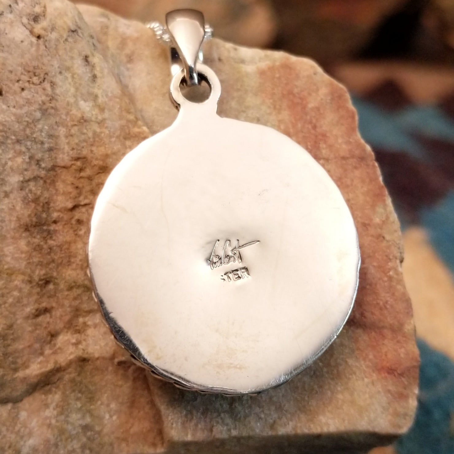 Close-up of the artisan's stamped signature.