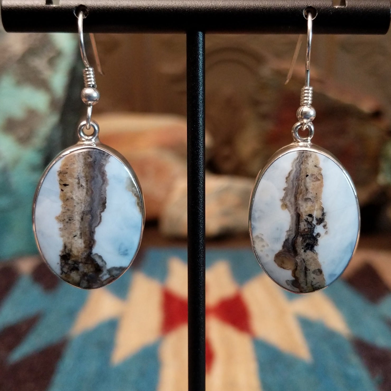 Sterling silver dangle earrings with Arizona blue opal set in oval bezels.