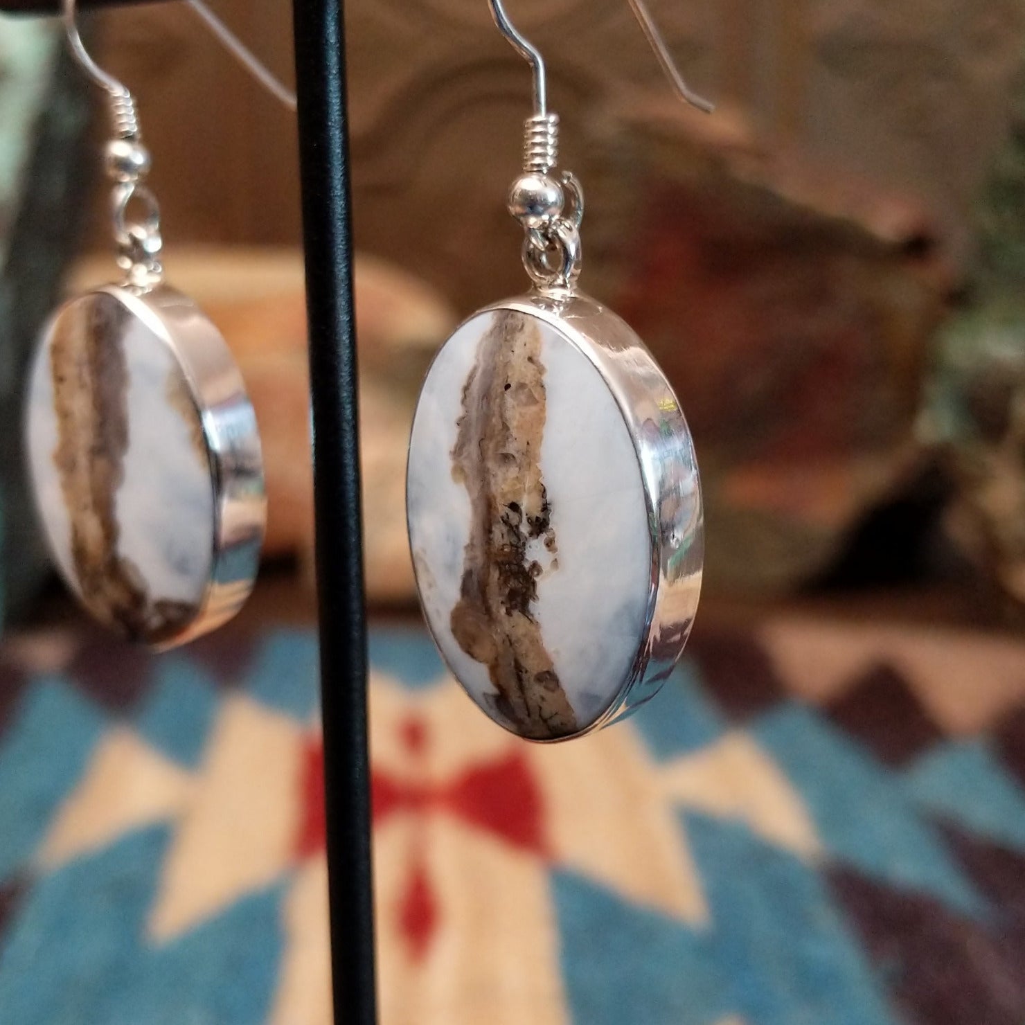 Sterling silver dangle earrings with Arizona blue opal set in oval bezels.
