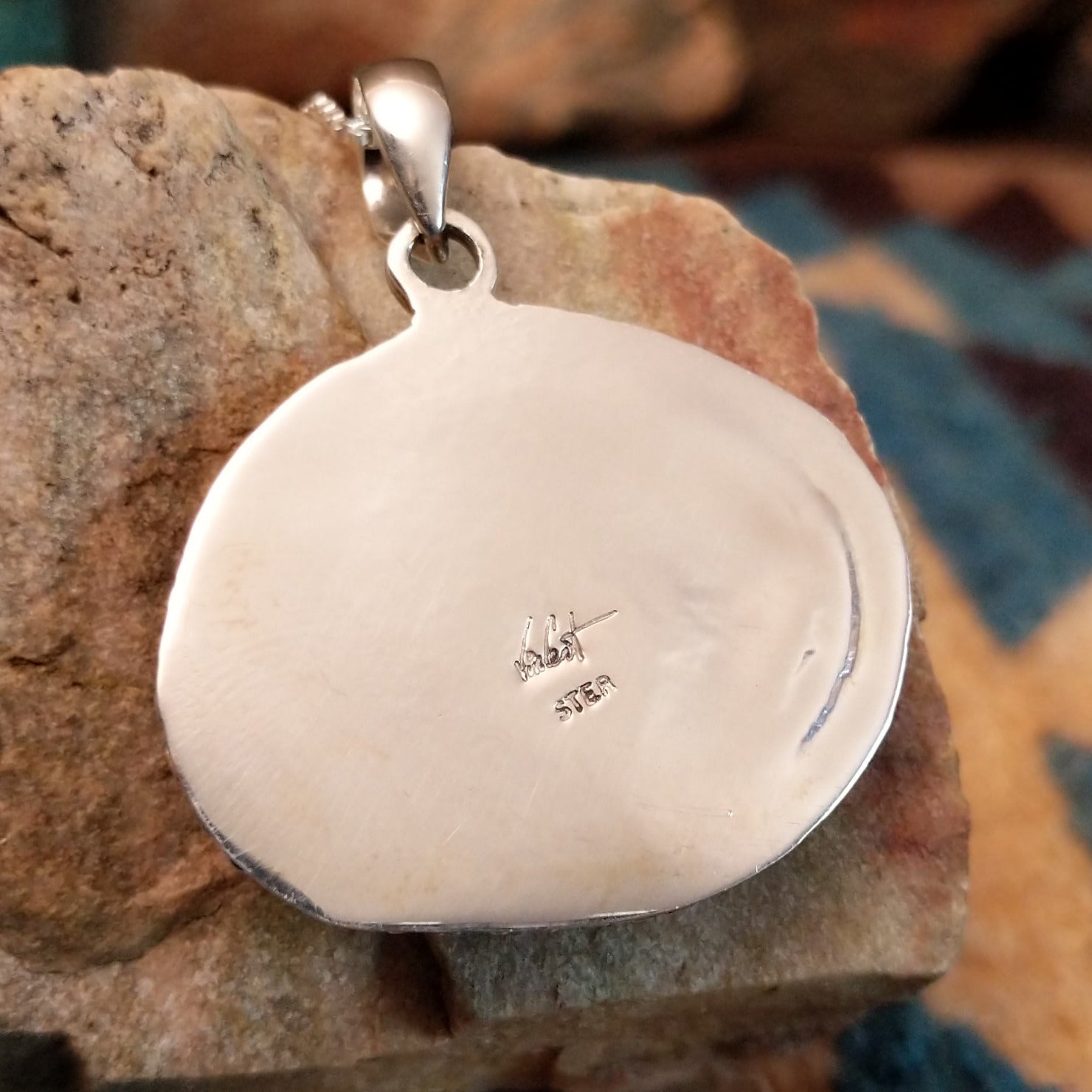 Close-up of the artisan's stamped signature.