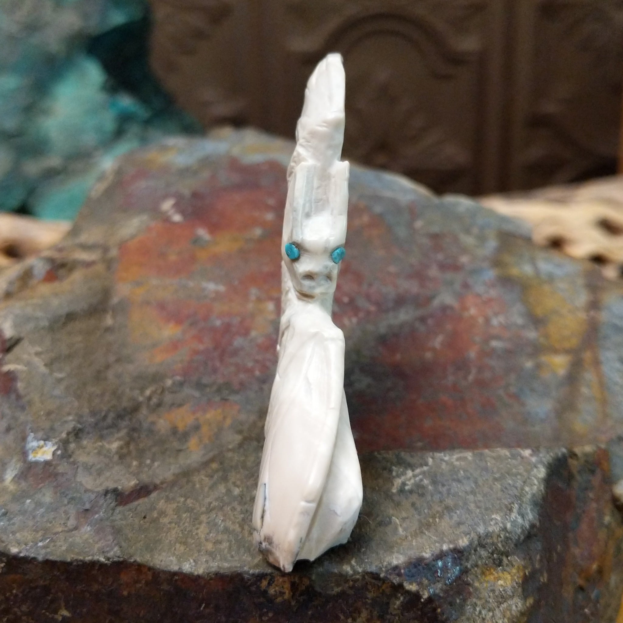 Bat Zuni fetish carving by Derrick Kaamasee with engraved wings, natural gray matrix, and turquoise inlaid eyes.