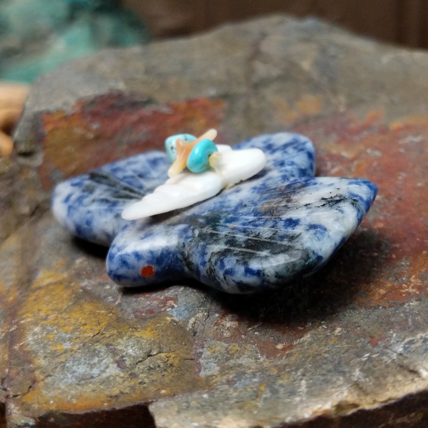 Bat Zuni fetish carving by Leland Boone in blue and white sodalite with a miniature offering bundle featuring turquoise and shell beads.
