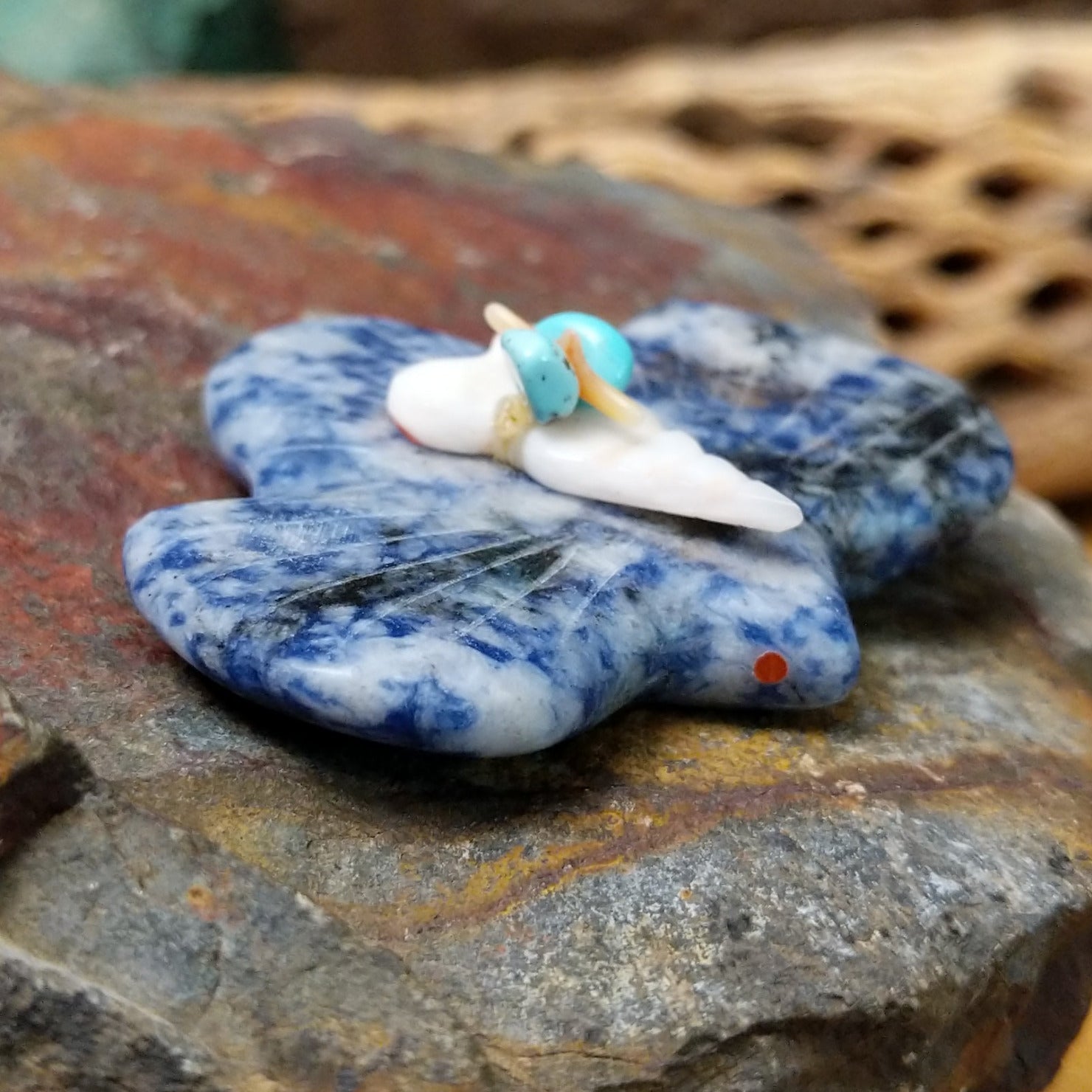 Bat Zuni fetish carving by Leland Boone in blue and white sodalite with a miniature offering bundle featuring turquoise and shell beads.