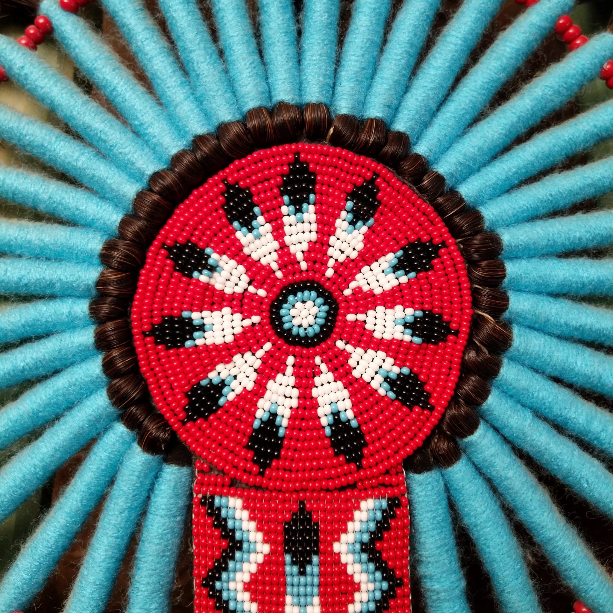 Blue Navajo Bustle artifact reproduction by Linda Lee with beadwork by Dorothy Manning, featuring turquoise, red, black, and white beadwork with dark horsehair accents.