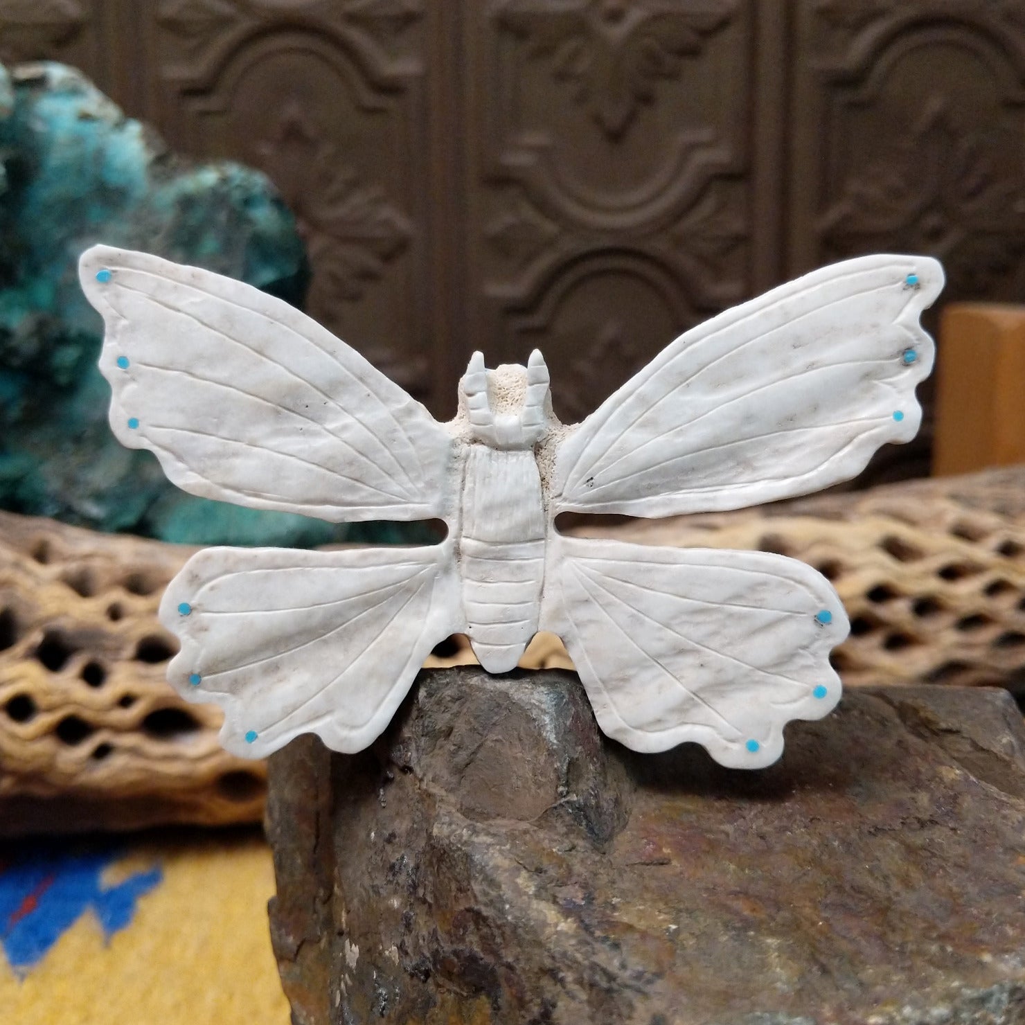 Butterfly Zuni fetish carving by Fitz Kiyite in pale stone with engraved wings and turquoise inlay accents along the wing edges.