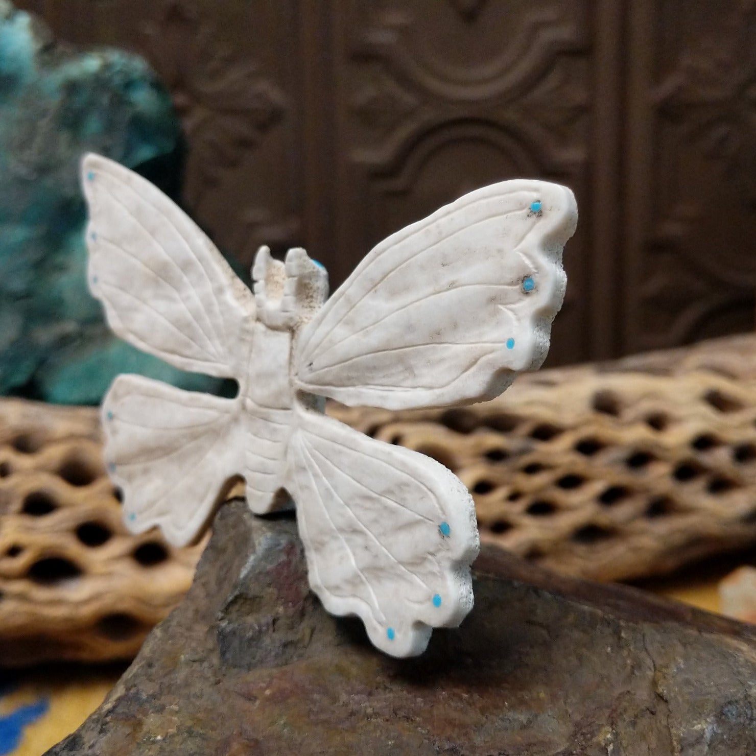 Butterfly Zuni fetish carving by Fitz Kiyite in pale stone with engraved wings and turquoise inlay accents along the wing edges.