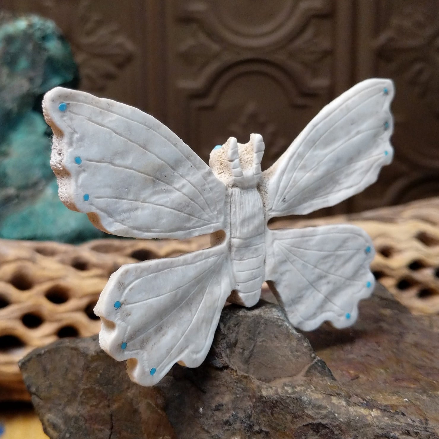 Butterfly Zuni fetish carving by Fitz Kiyite in pale stone with engraved wings and turquoise inlay accents along the wing edges.