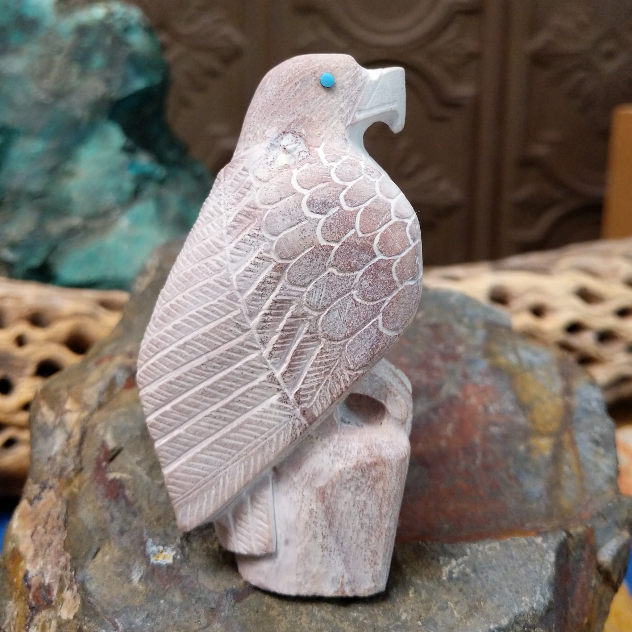 Hawk Zuni fetish carving by Derrick Kaamasee with engraved feather details, turquoise inlaid eye, and carved perch.