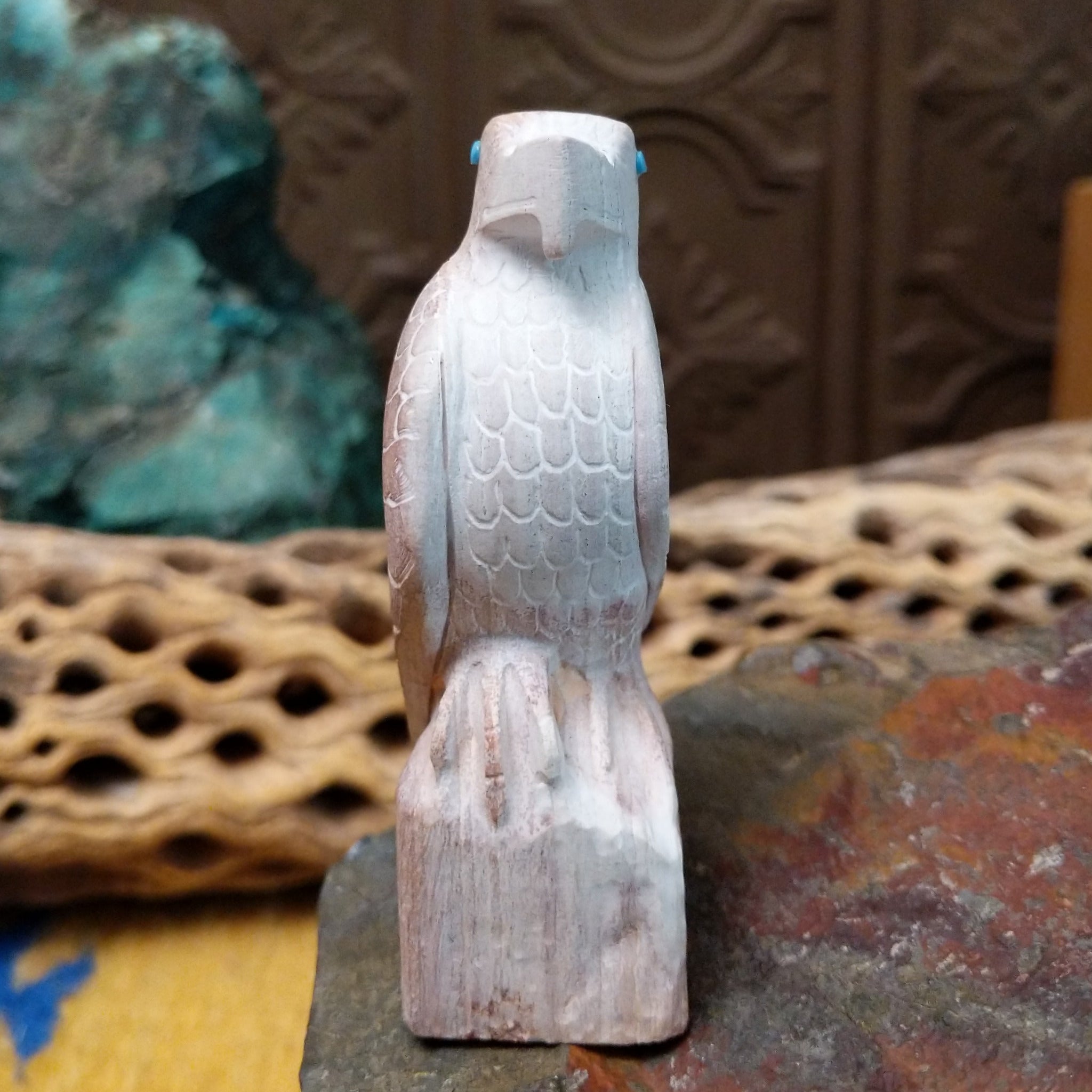 Hawk Zuni fetish carving by Derrick Kaamasee with engraved feather details, turquoise inlaid eye, and carved perch.