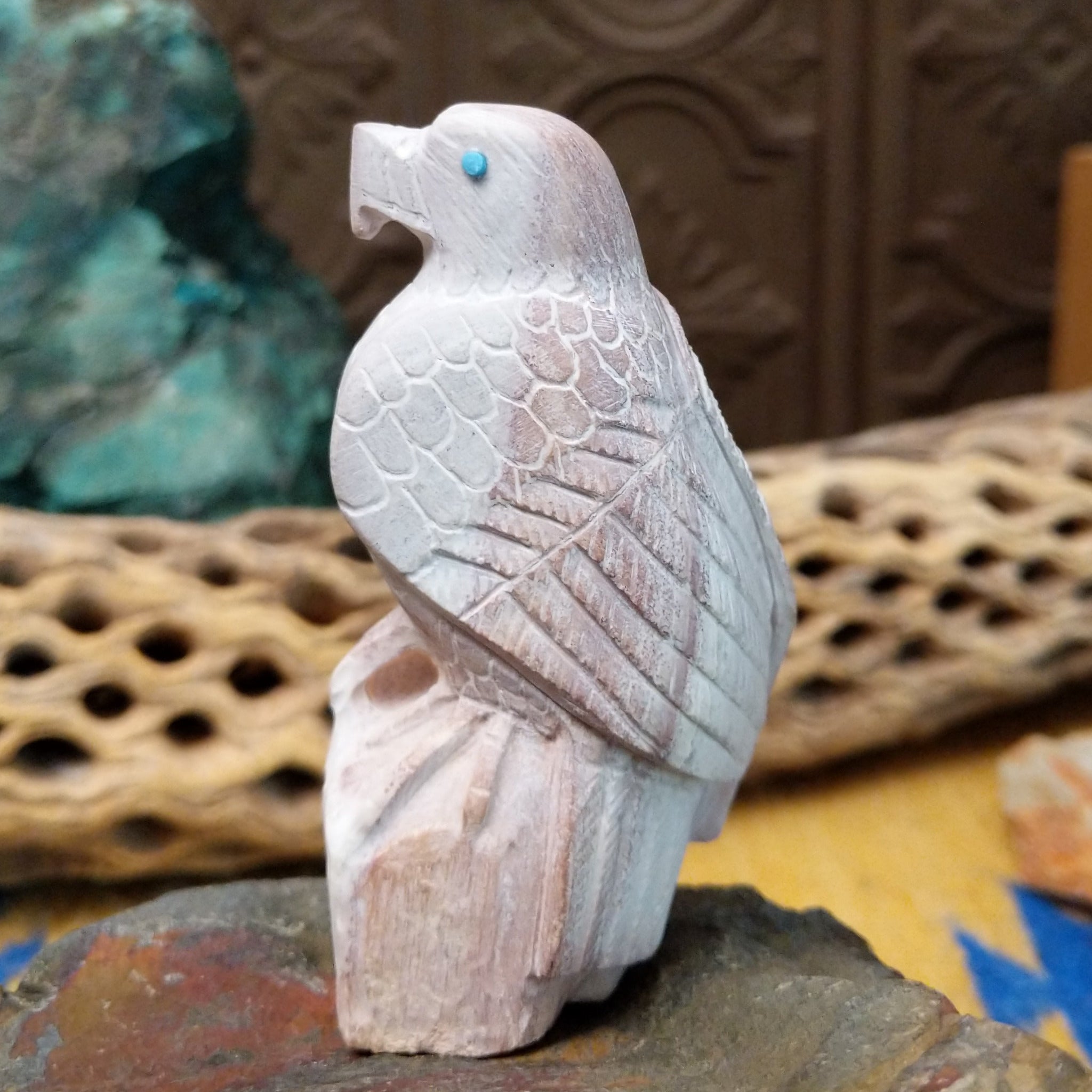 Hawk Zuni fetish carving by Derrick Kaamasee with engraved feather details, turquoise inlaid eye, and carved perch.