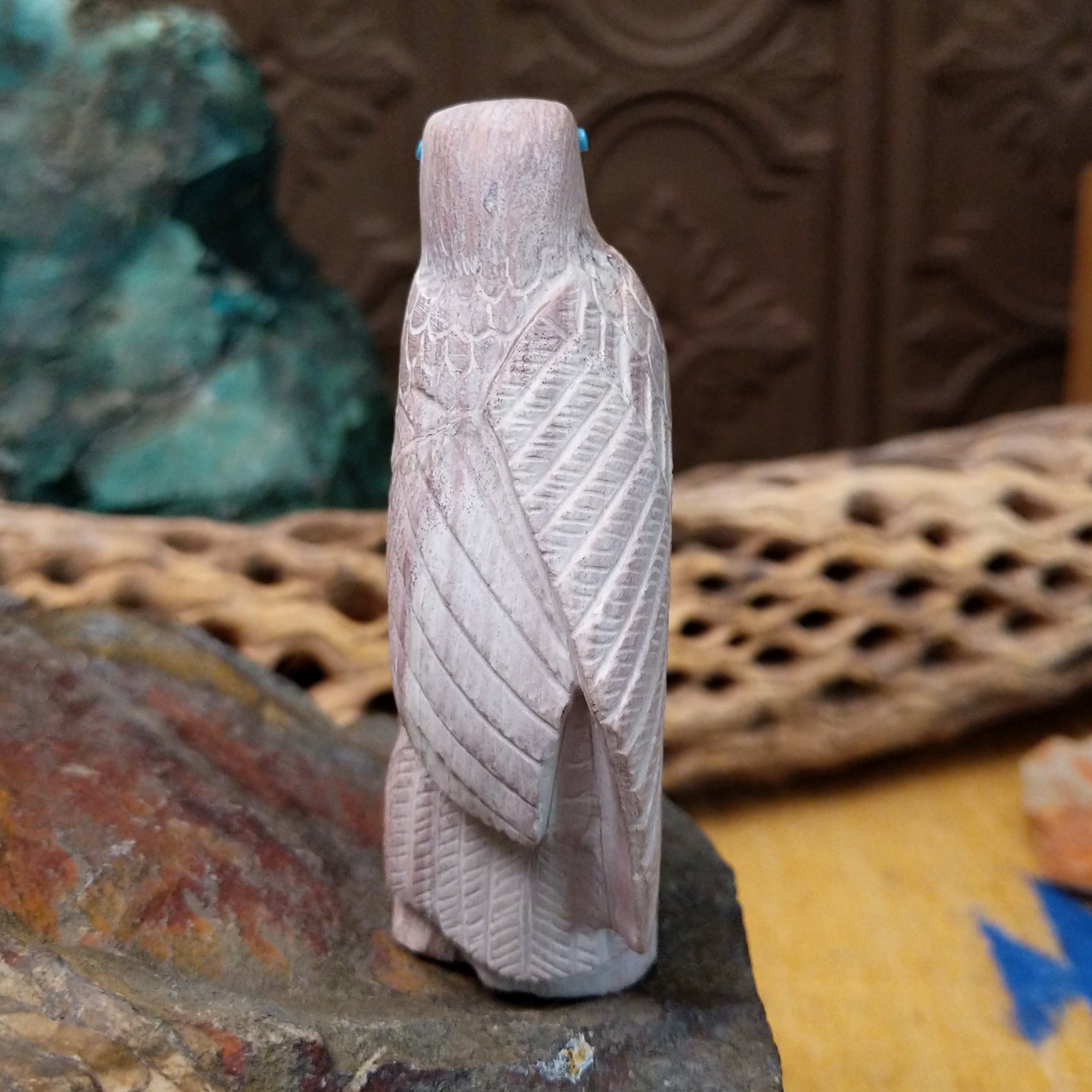 Hawk Zuni fetish carving by Derrick Kaamasee with engraved feather details, turquoise inlaid eye, and carved perch.