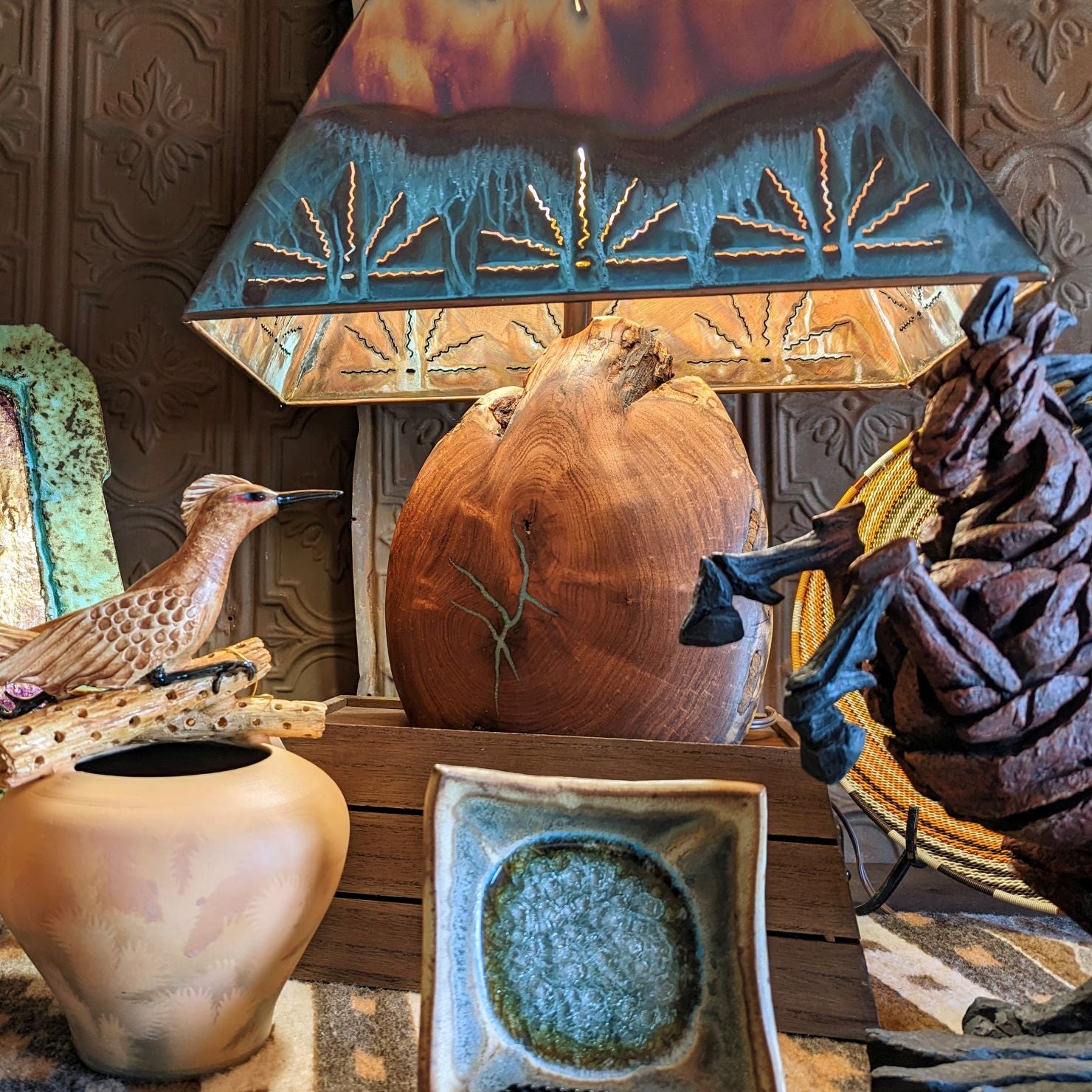 Collection of various home decoration items such as a horse and roadrunner statue, a unique wooden and turquoise inlay lamp, vibrant pottery and more stunning collectables.