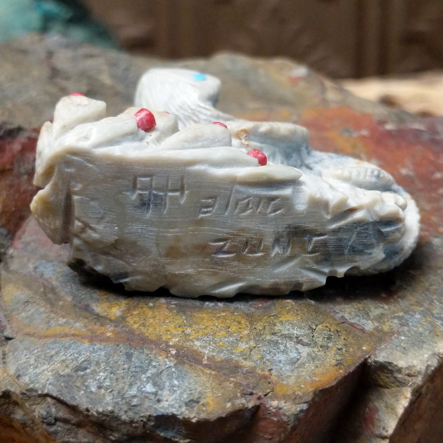 Close up of artist's etched signature. 