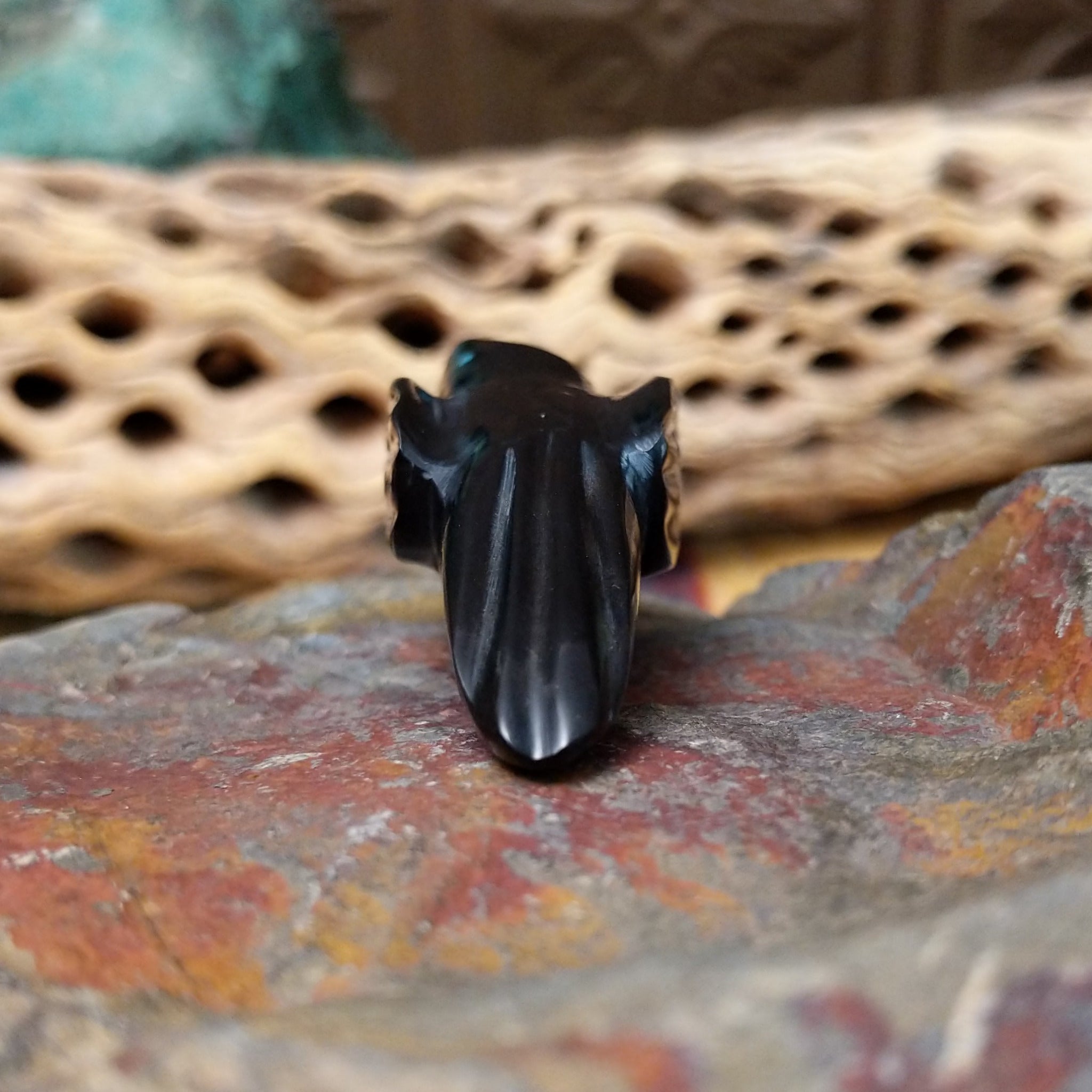 Magpie Zuni fetish carving by Delvin Leekya in black stone with shell wing inlay and turquoise eye.