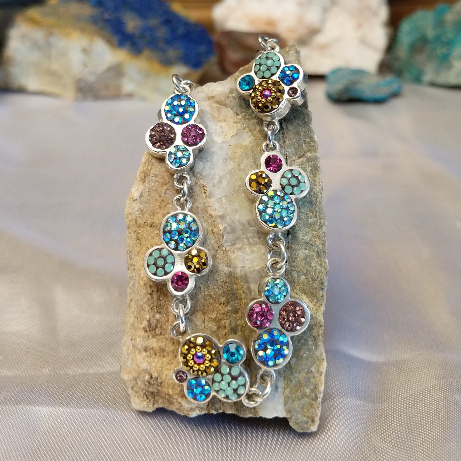 Sterling silver bracelet with Austrian crystals set in floral bezels.