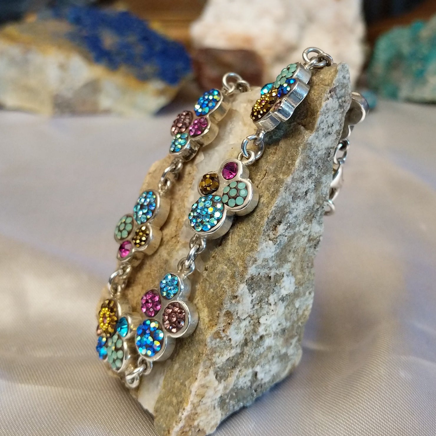 Sterling silver bracelet with Austrian crystals set in floral bezels.