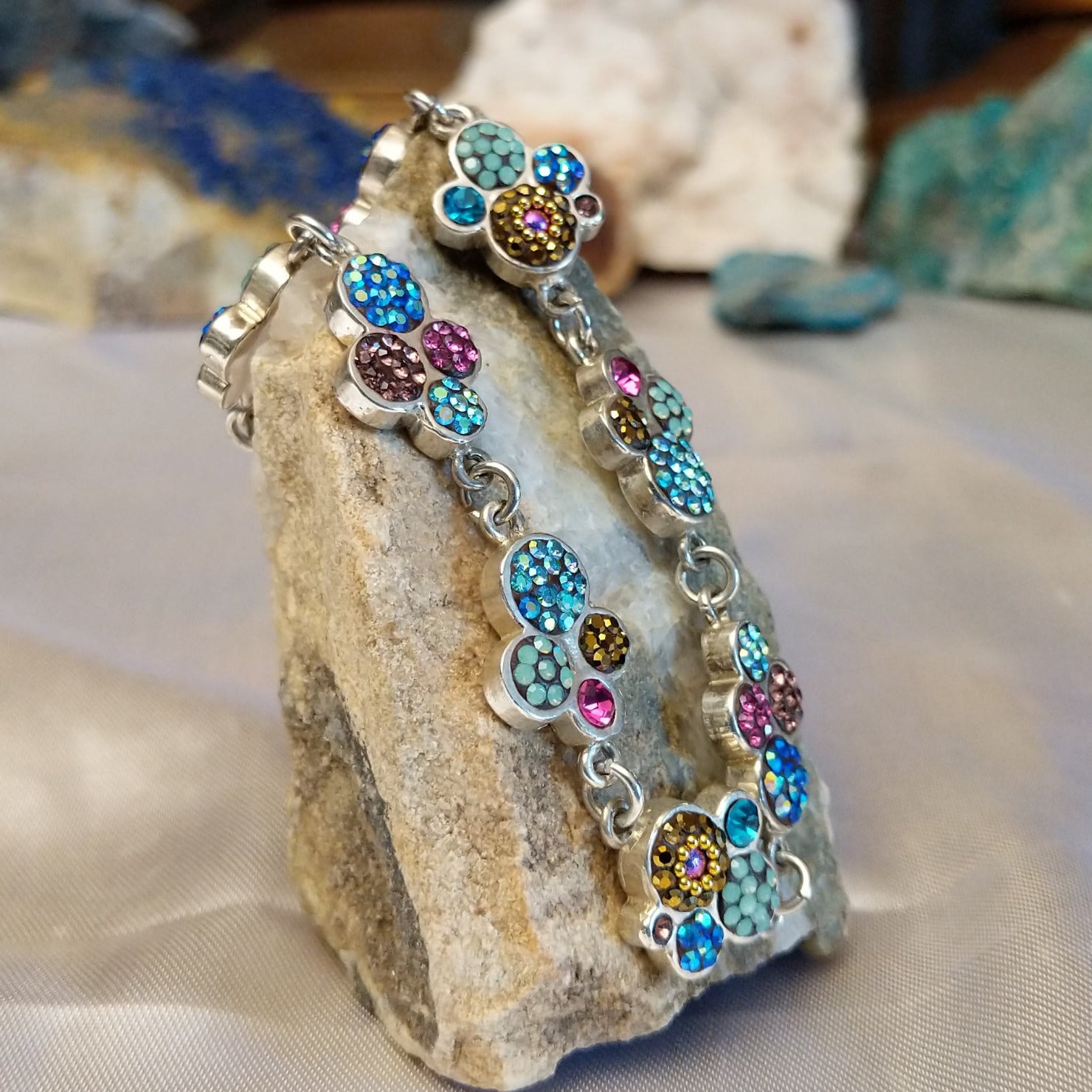 Sterling silver bracelet with Austrian crystals set in floral bezels.