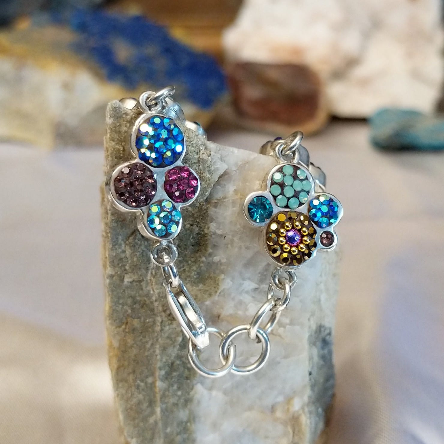 Sterling silver bracelet with Austrian crystals set in floral bezels.