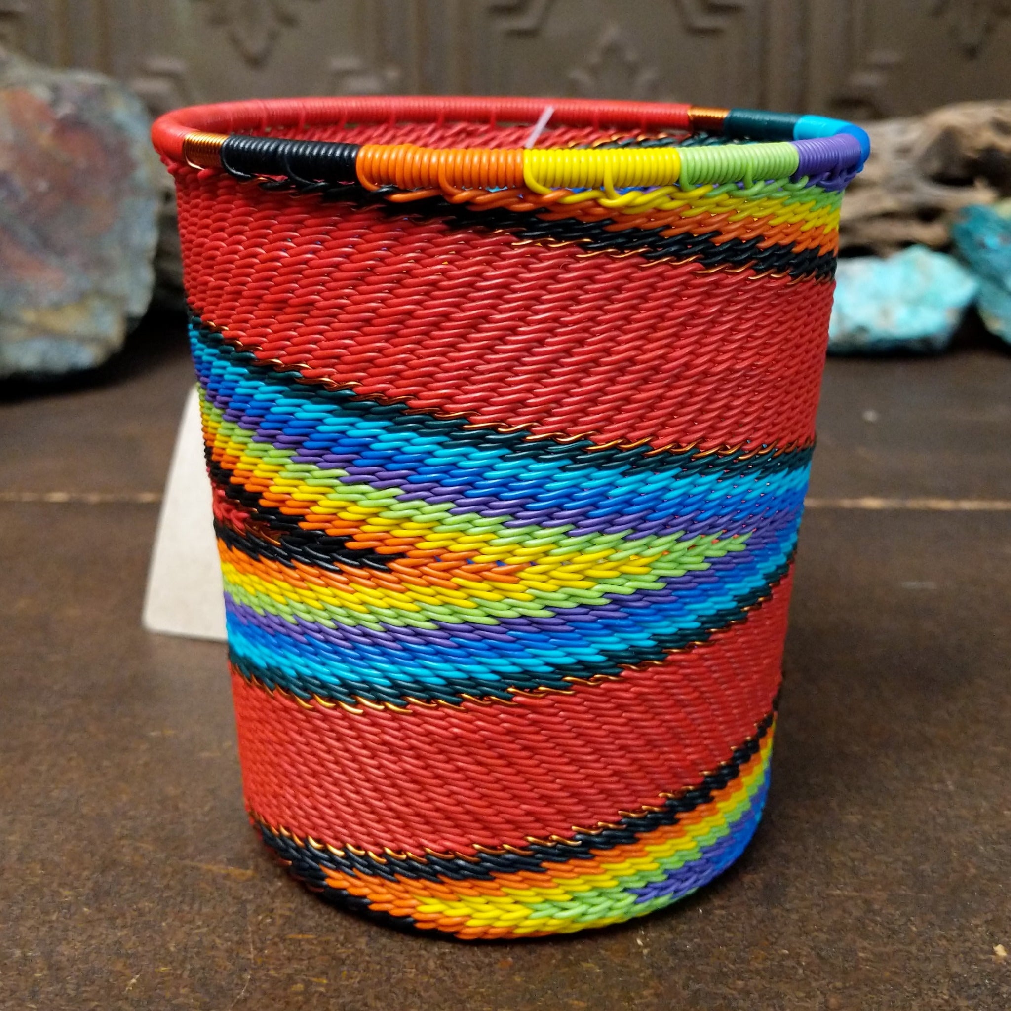 Handwoven multicolor wire art cup by Bridge for Africa featuring vibrant recycled wire in a colorful diagonal pattern, ideal as a decorative container, utensil holder, or pencil cup.