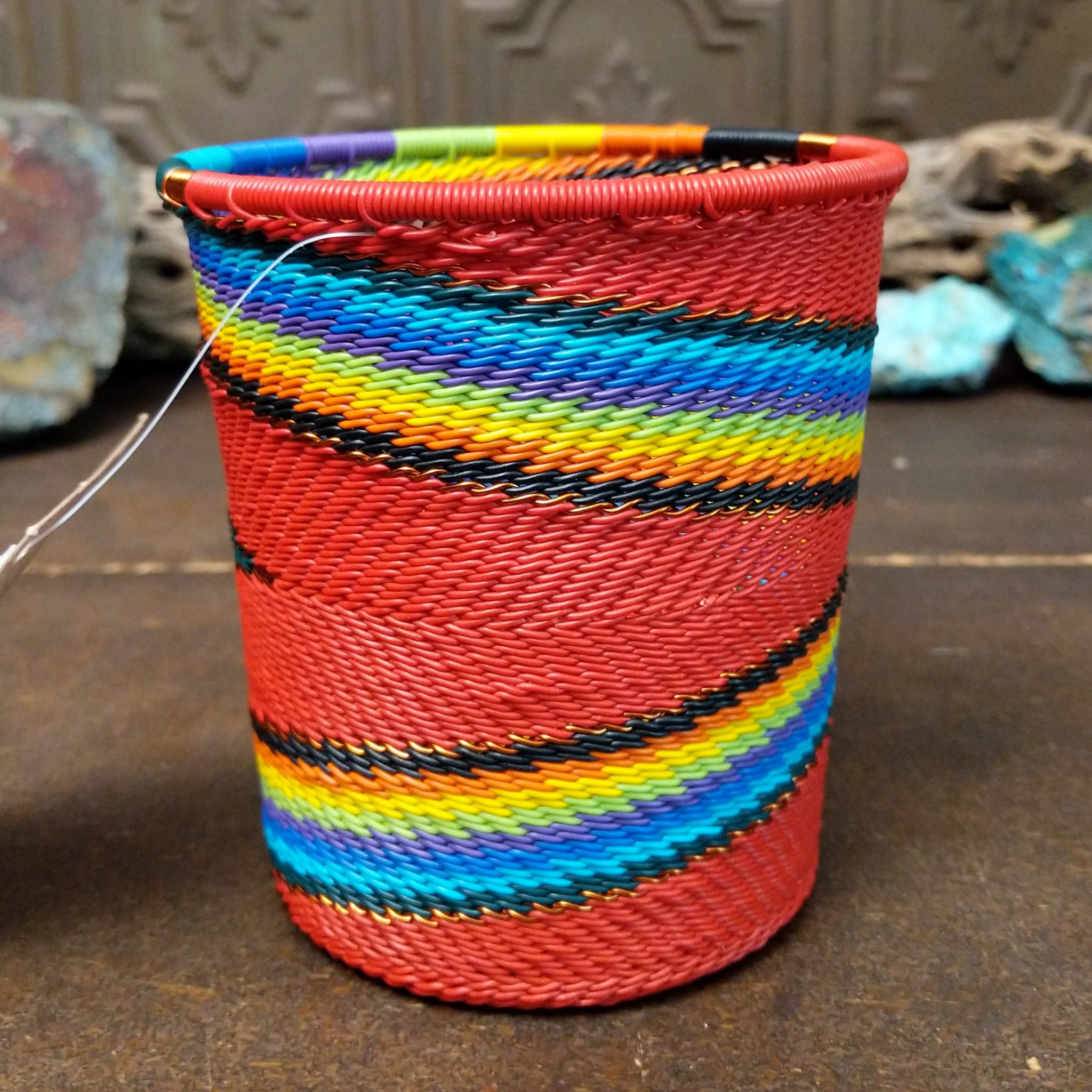Handwoven multicolor wire art cup by Bridge for Africa featuring vibrant recycled wire in a colorful diagonal pattern, ideal as a decorative container, utensil holder, or pencil cup.