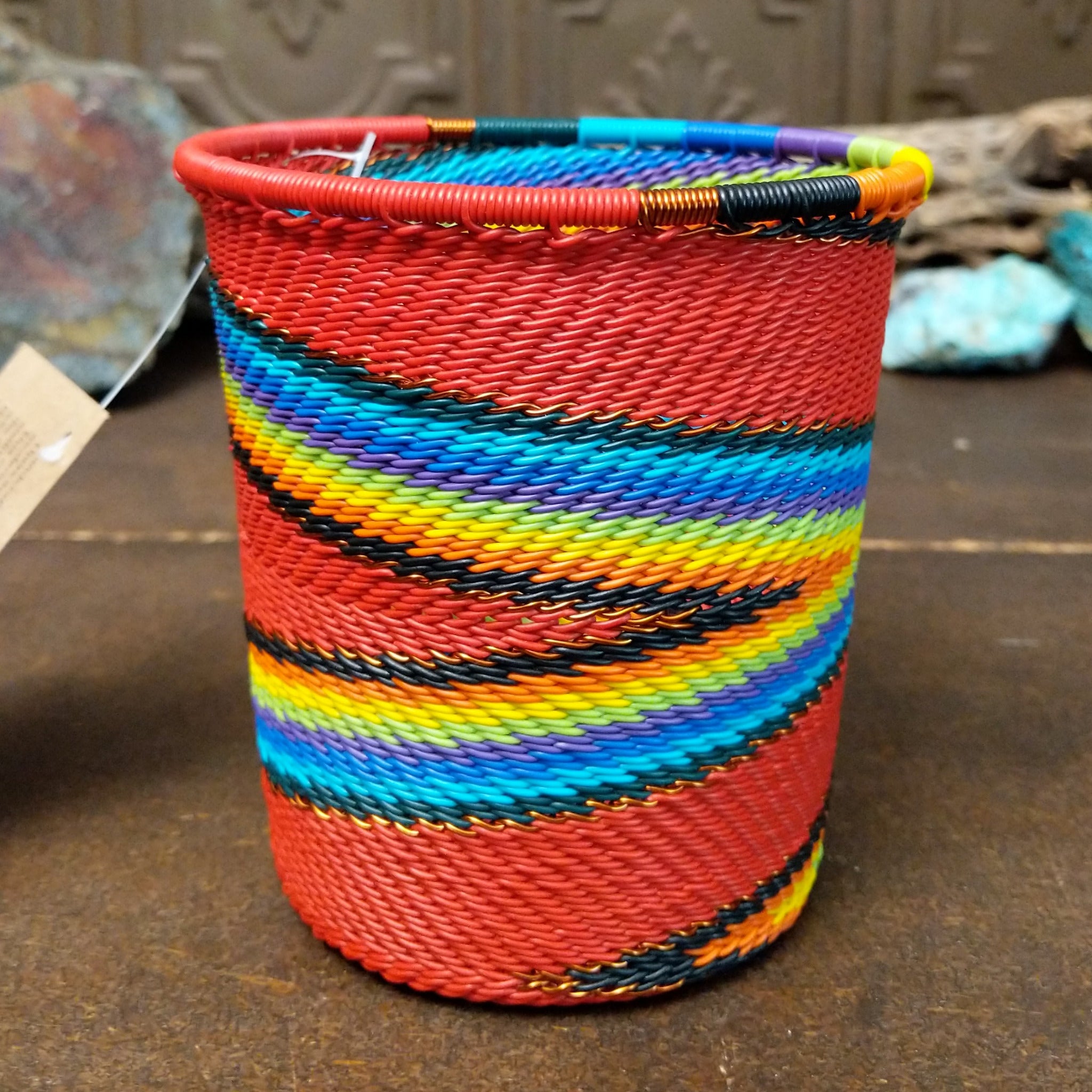 Handwoven multicolor wire art cup by Bridge for Africa featuring vibrant recycled wire in a colorful diagonal pattern, ideal as a decorative container, utensil holder, or pencil cup.